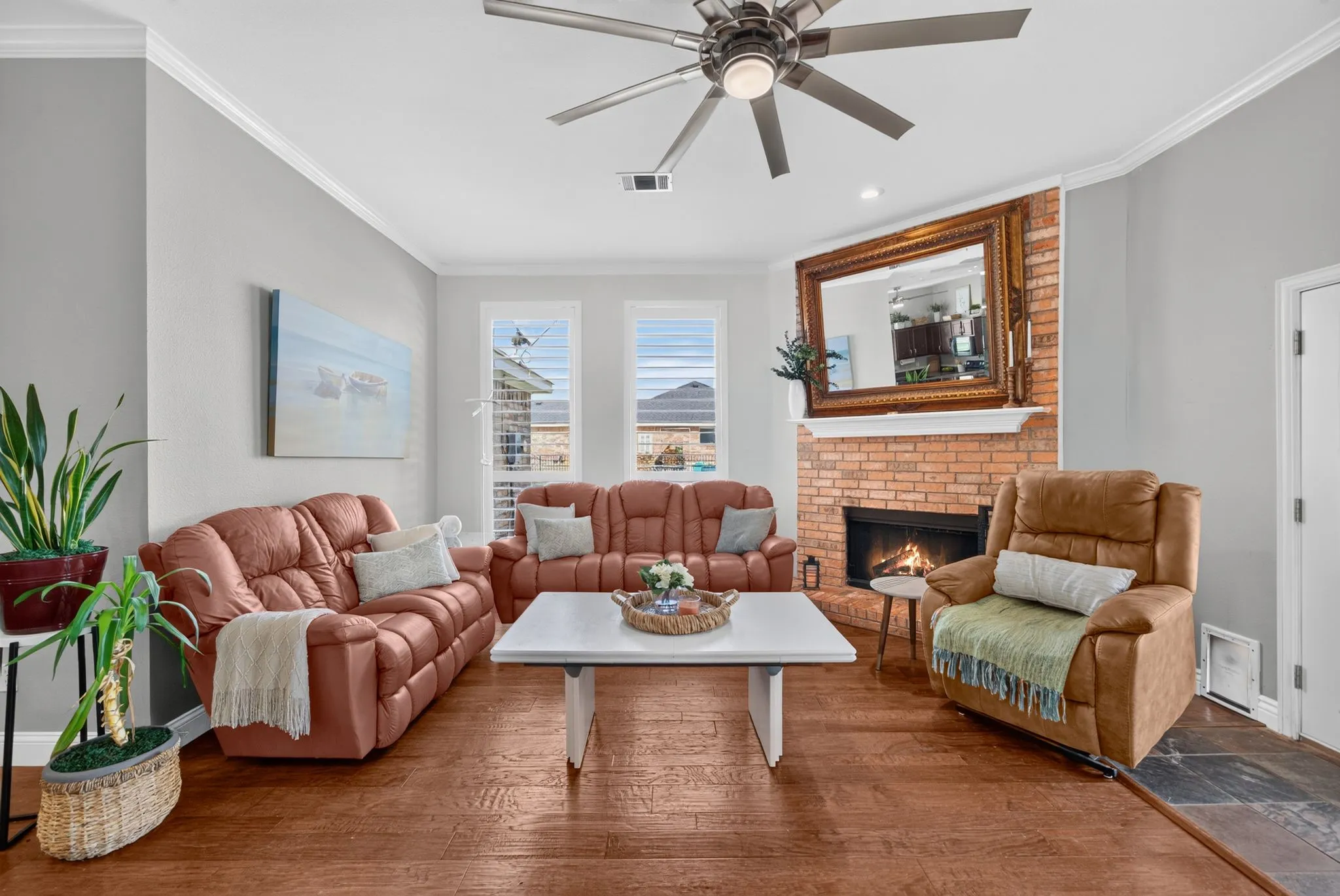 Living area featuring wood-finish flooring and a brick fireplace