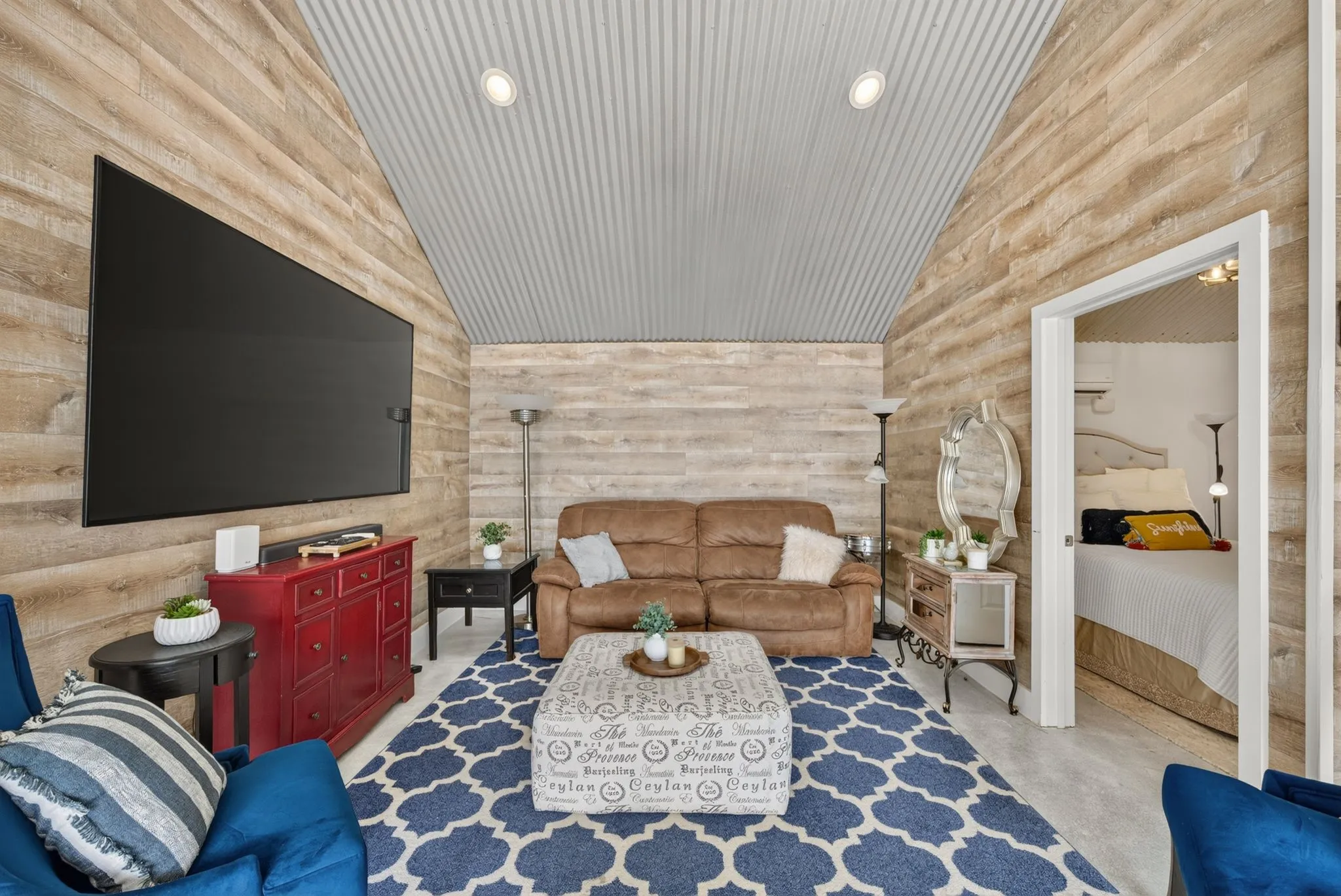 Vaulted ceiling with corrugated metal finish and recessed lighting