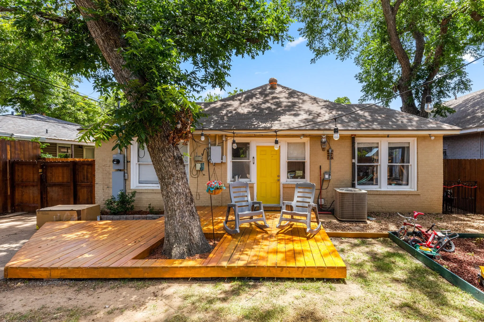 Spacious backyard featuring a brand-new deck and mature shade tree