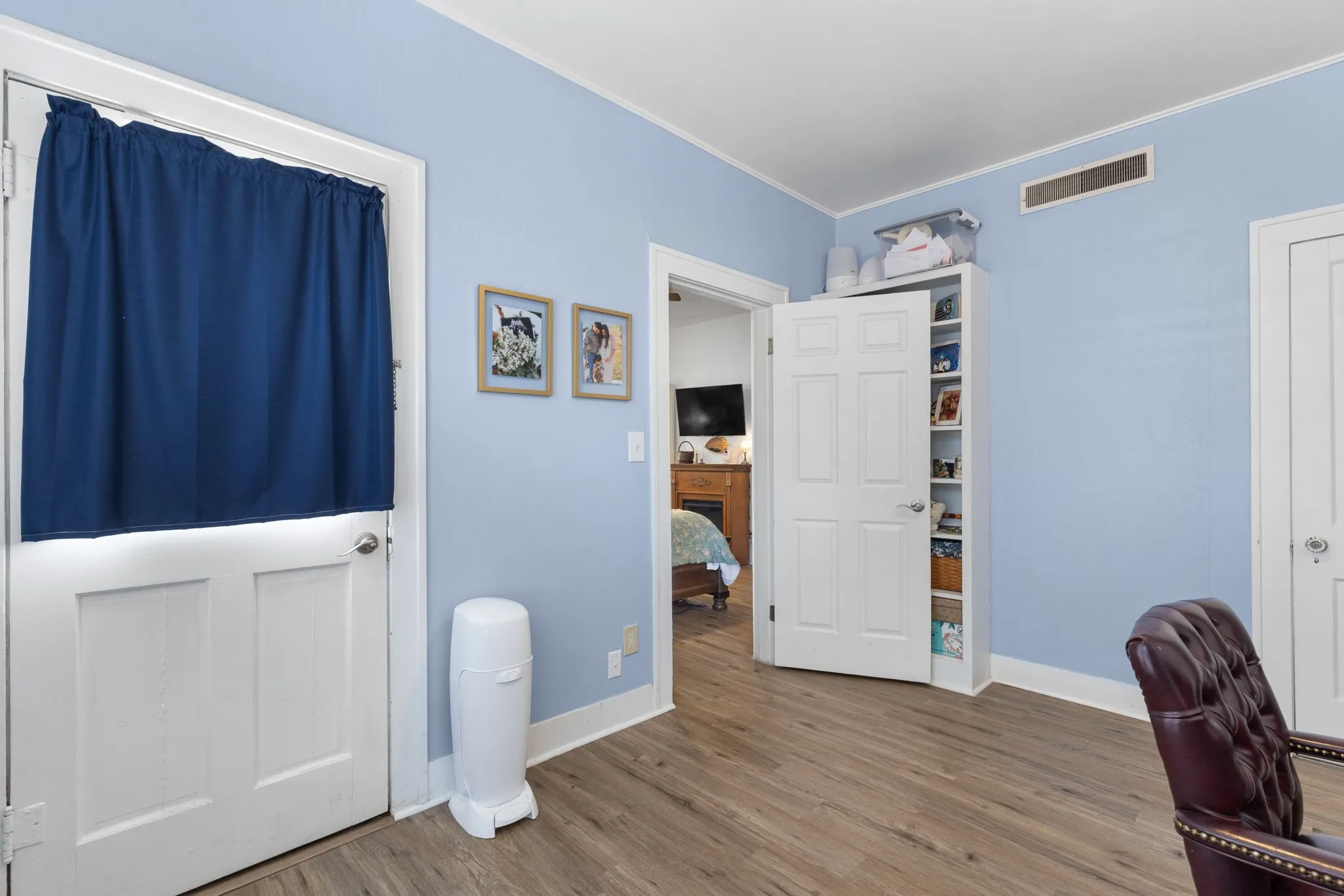 Bedroom or office with a side door to the driveway.