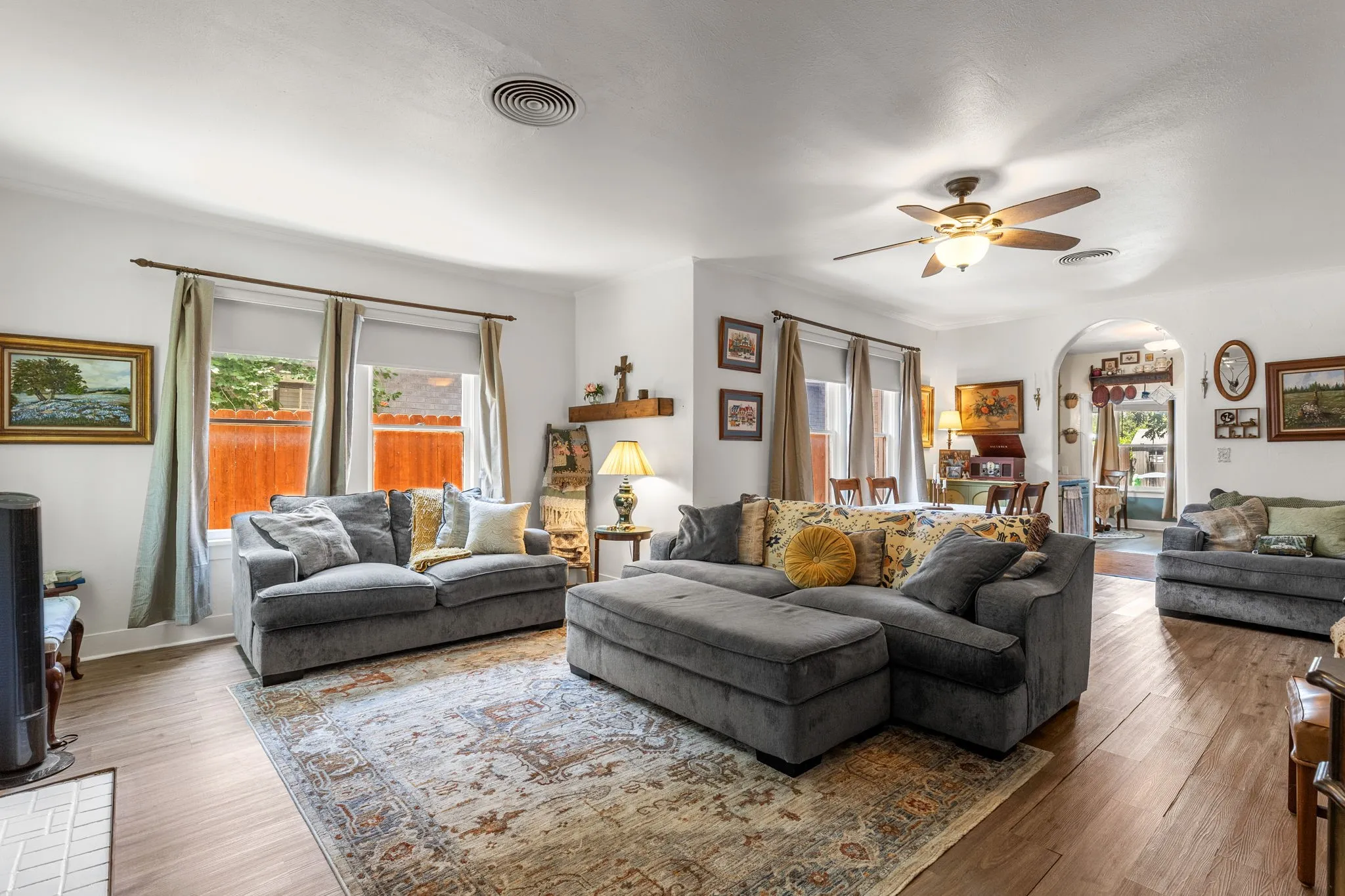 Expansive living area featuring light wood-finish flooring and abundant natural light