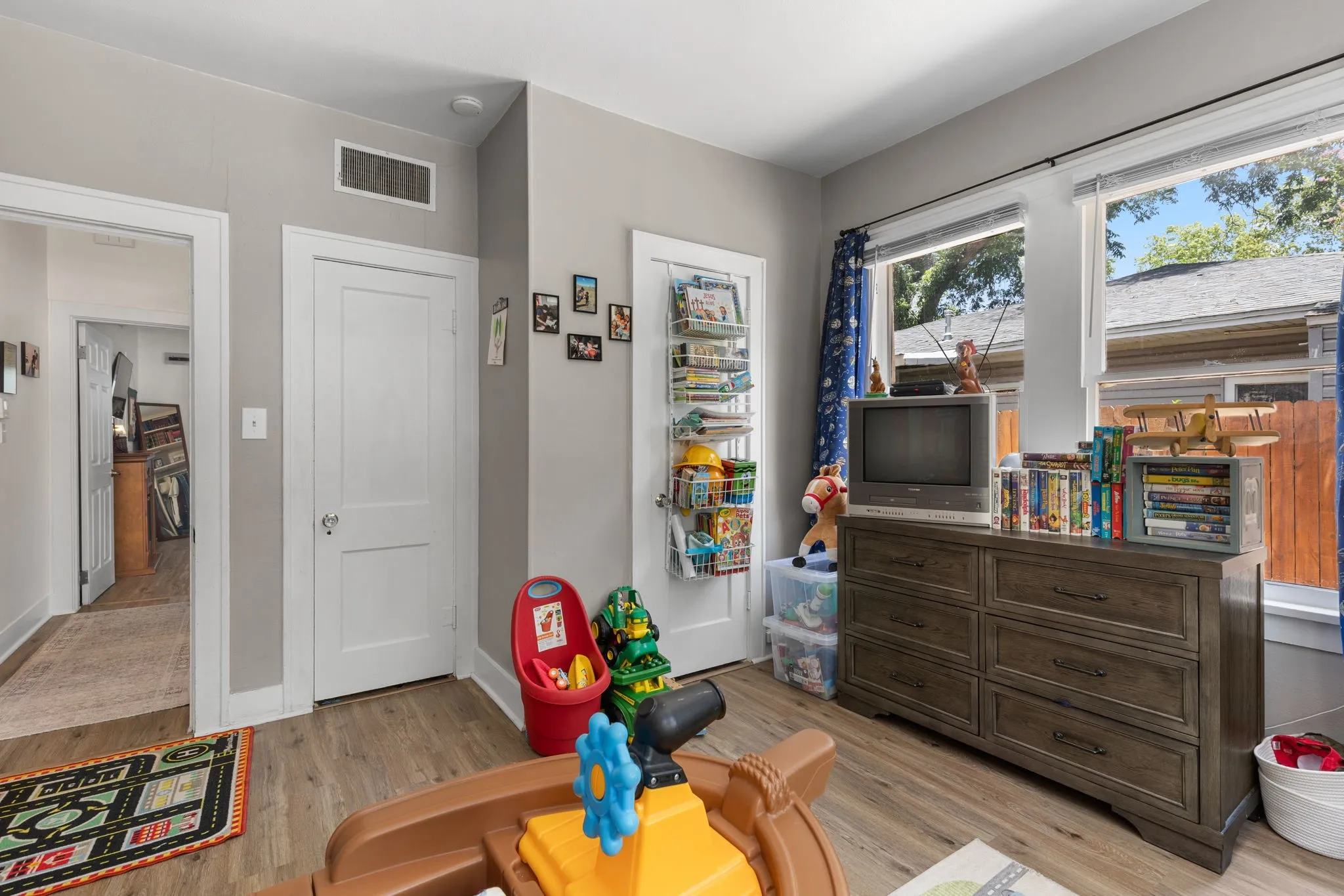 Bedroom featuring wood-like flooring, light wall paint, closet and white trim