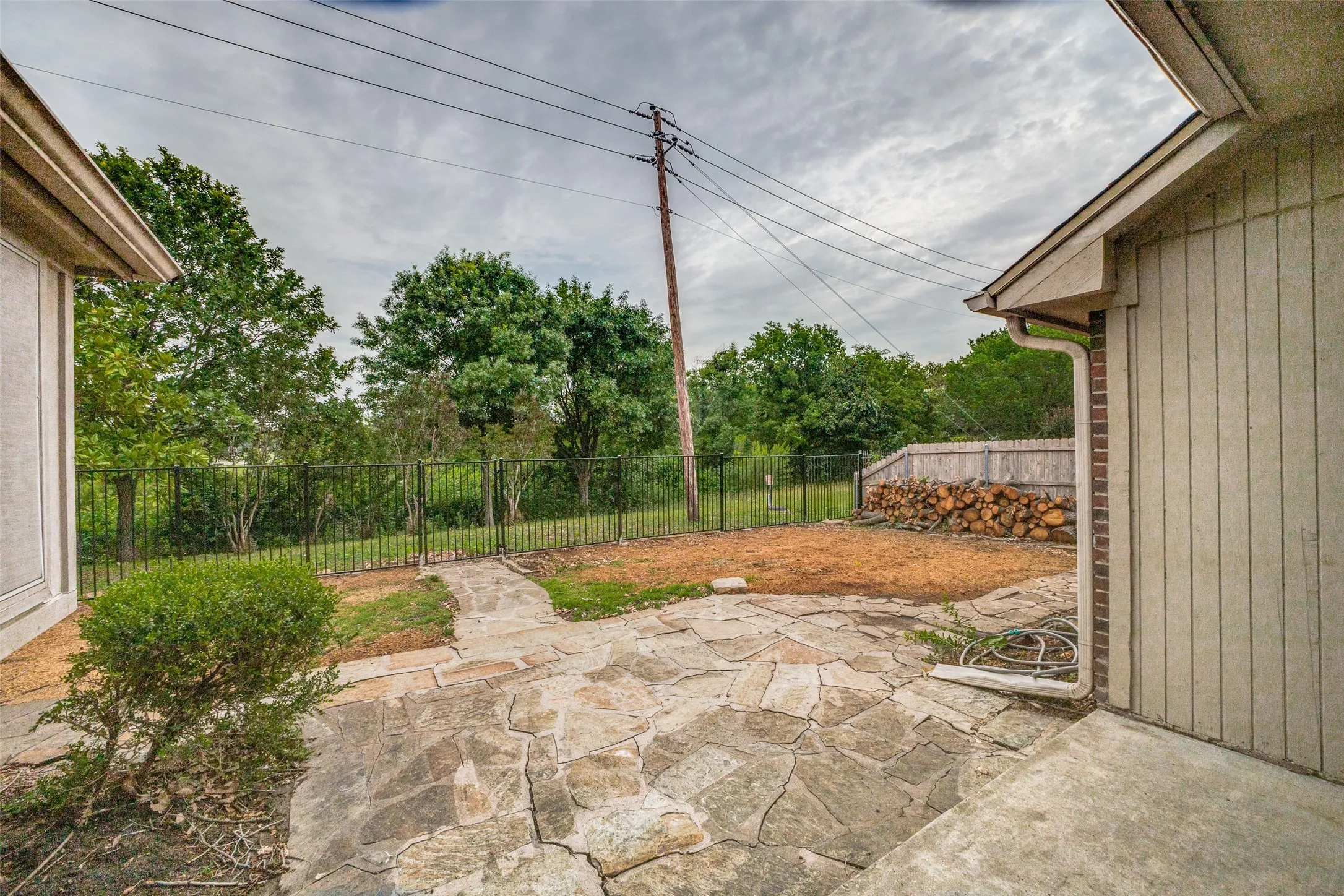 Rear patio featuring irregular flagstone paving and a concrete section