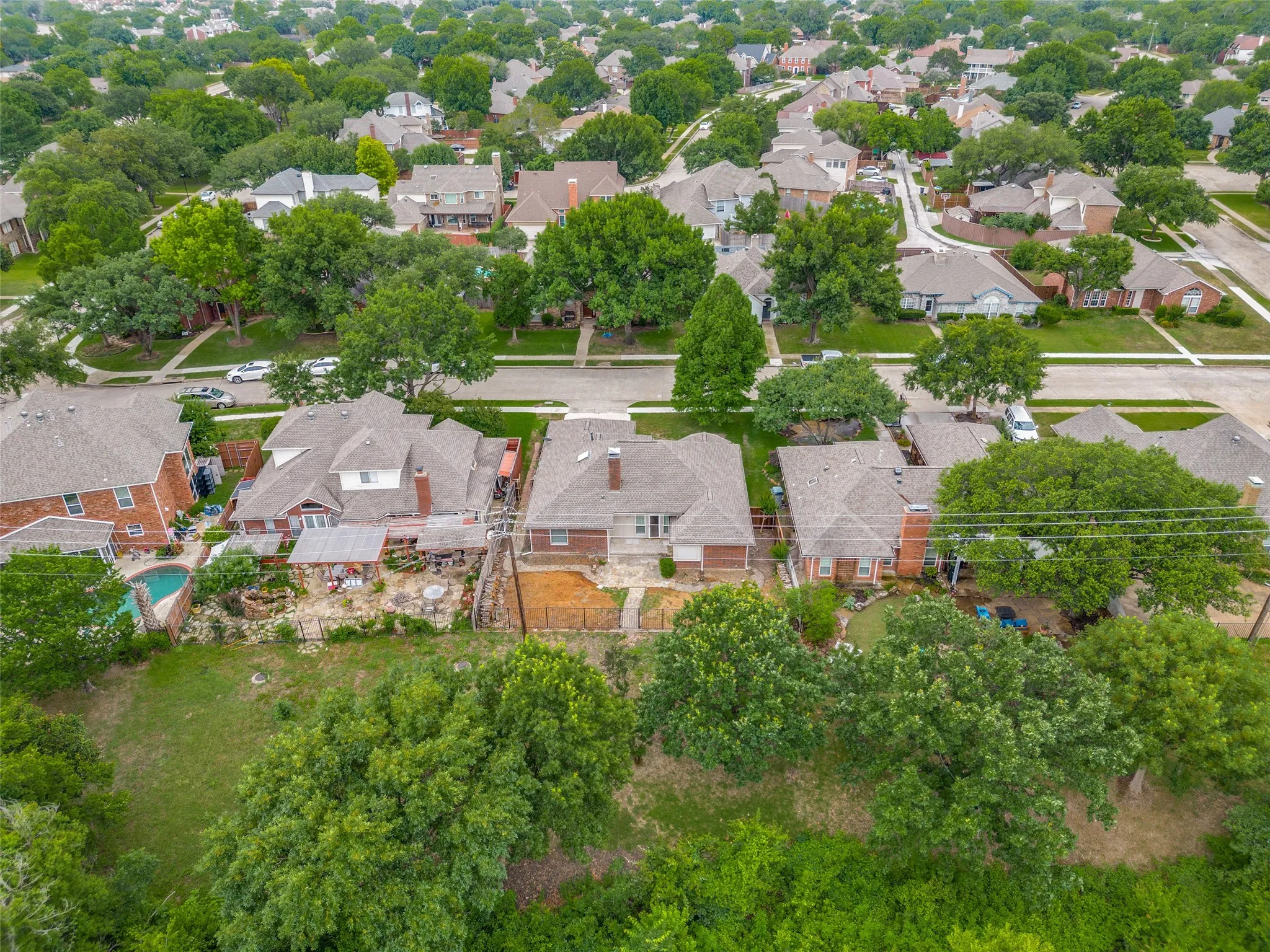 Aerial view of a residential neighborhood with tree-lined streets