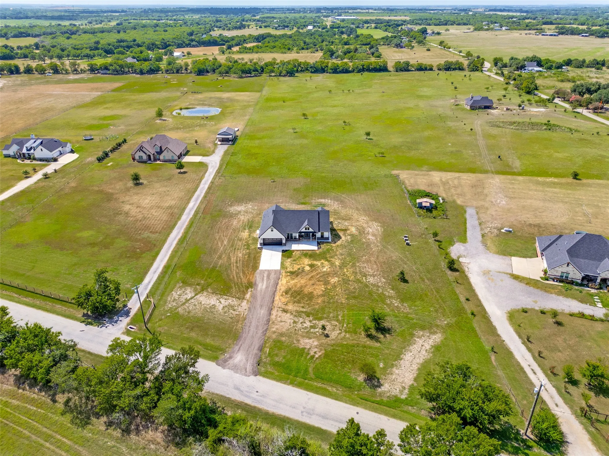 Expansive green acreage with a prominent central residence