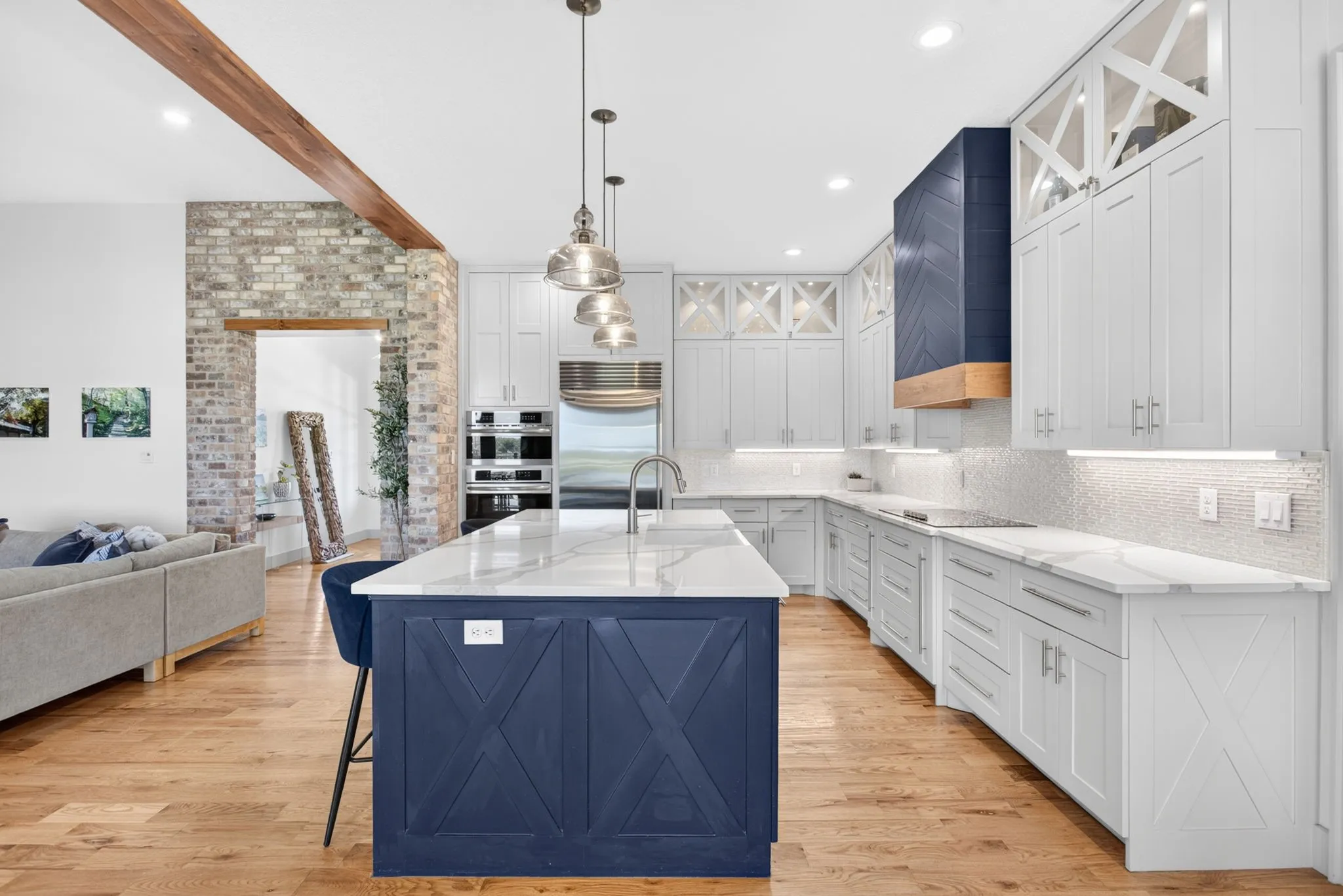 Spacious kitchen featuring a large central island with a white countertop and blue paneled base