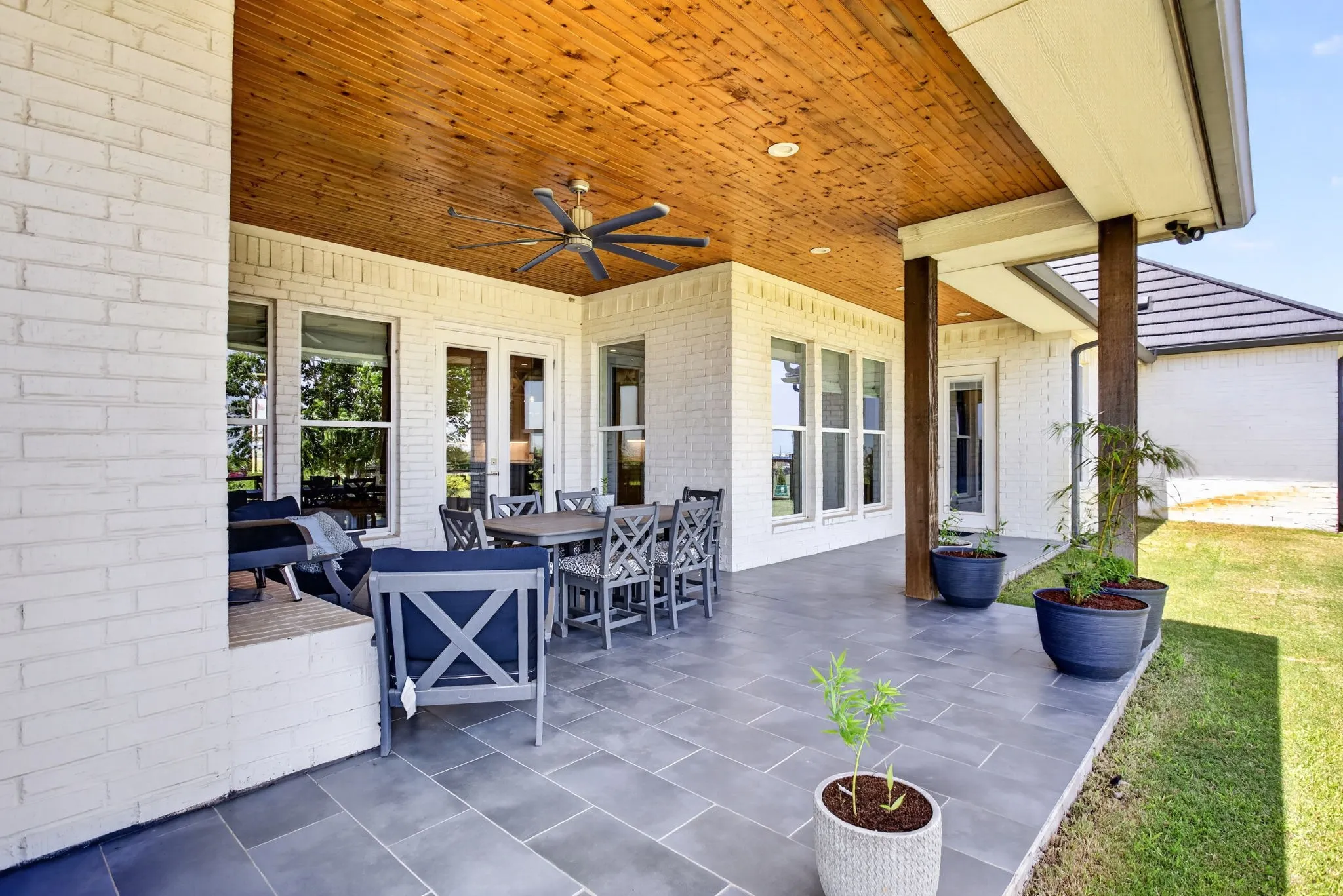 Covered patio featuring a wood-finish plank ceiling with a ceiling fan, recessed lighting, and gray-toned tile flooring