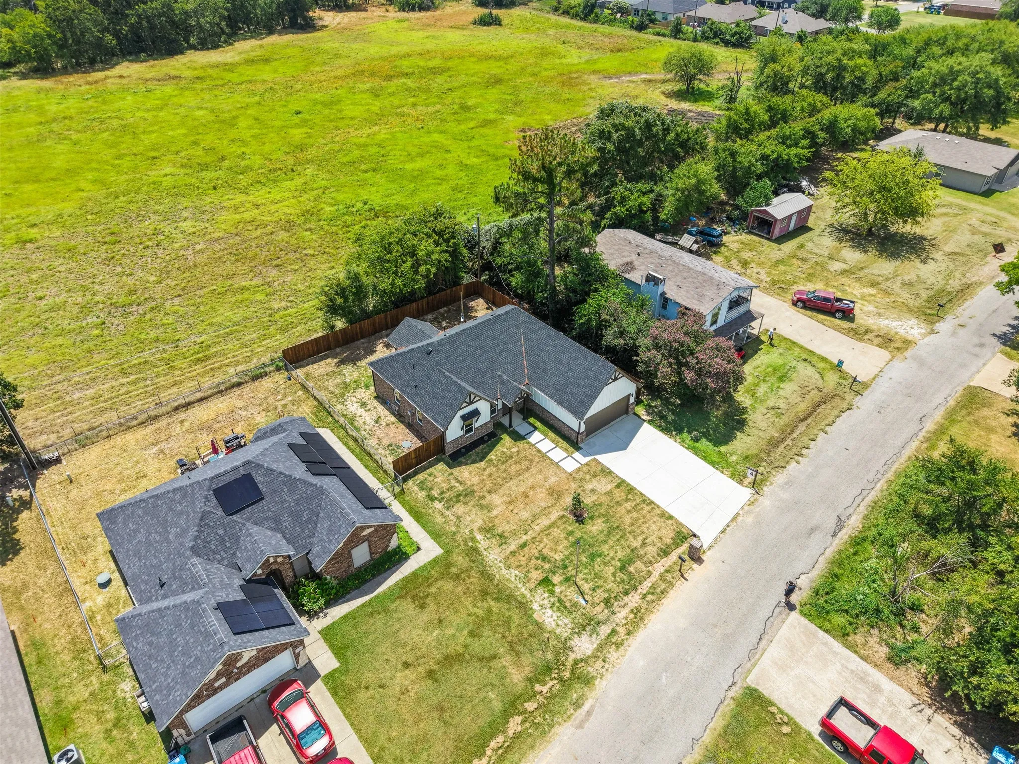 Rooftop solar panels on a single-story residence with an attached garage and a concrete driveway