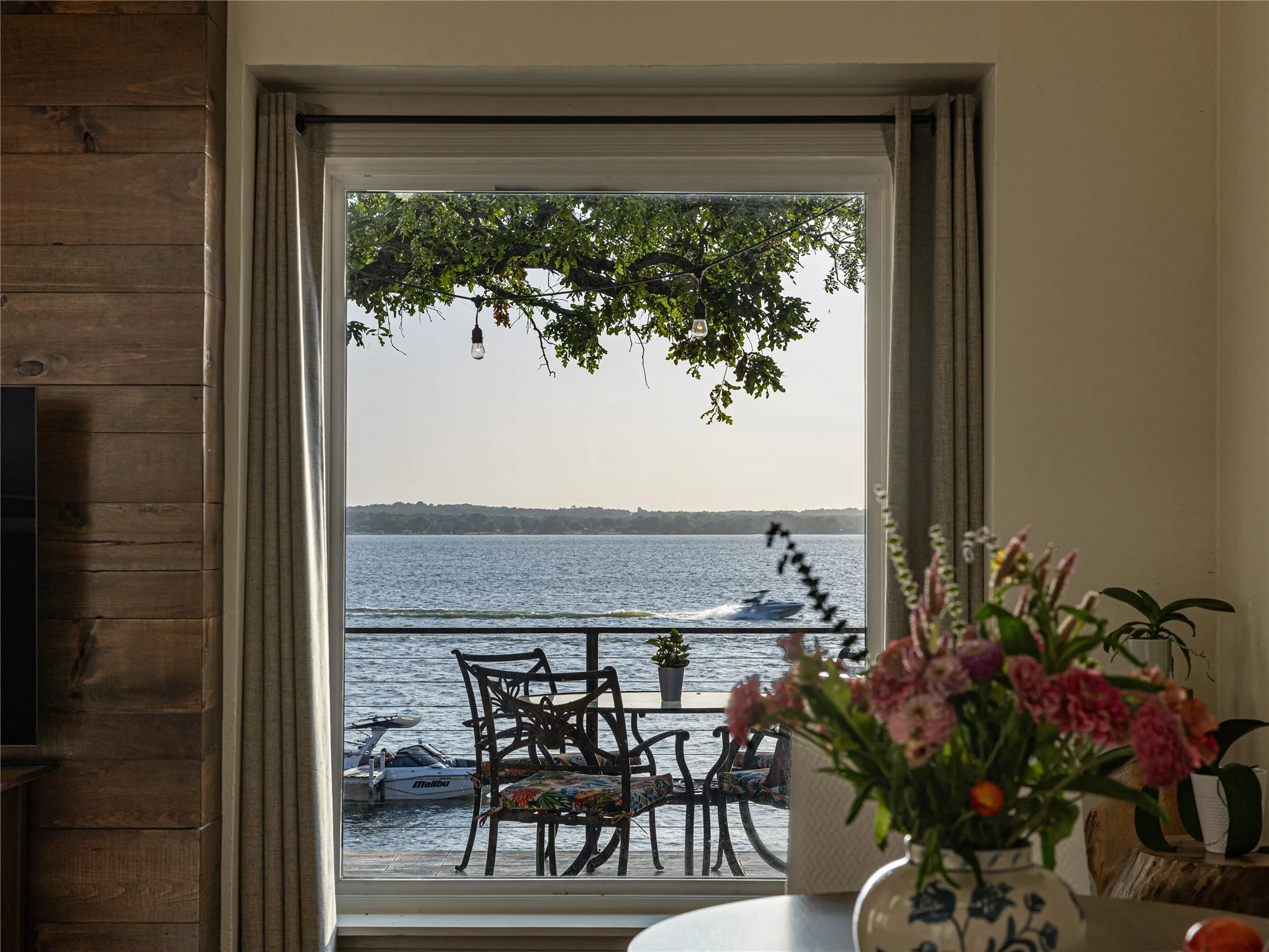 A living space framed by the presence of the lake beyond.