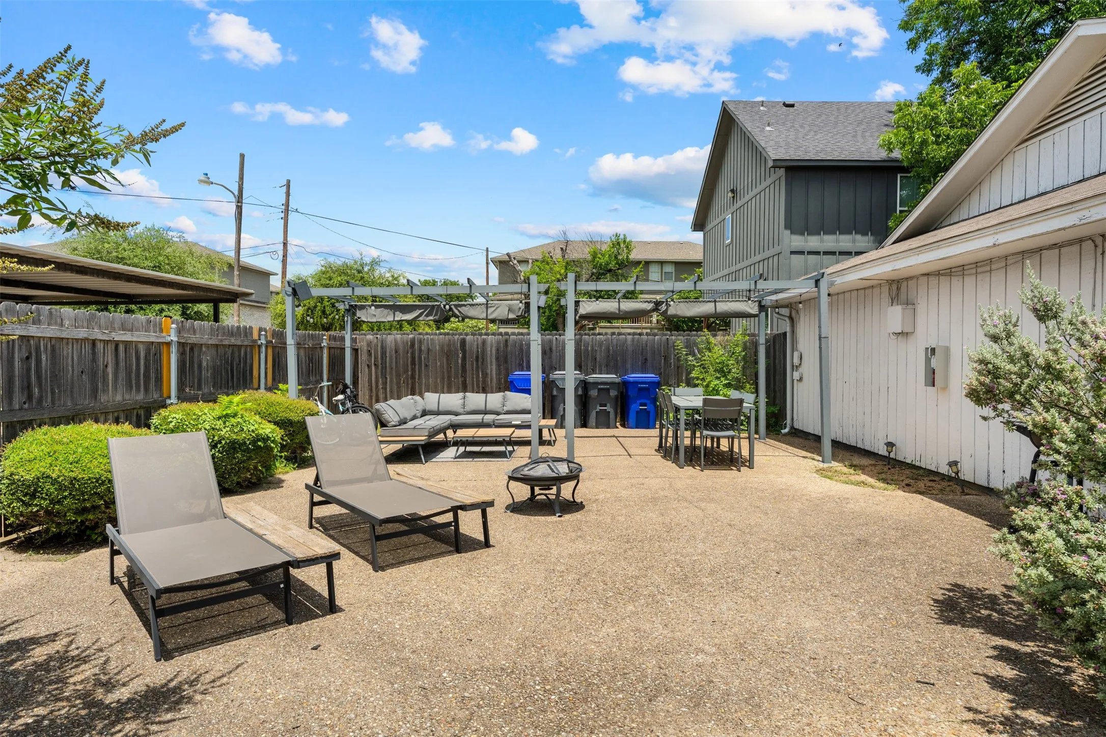 Spacious backyard featuring an exposed aggregate concrete patio