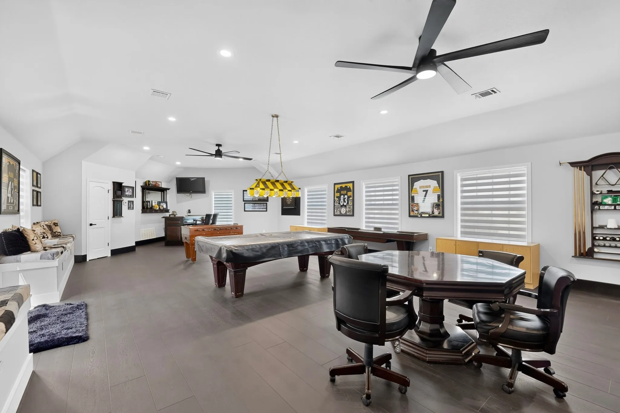 Spacious bonus room featuring wood-finish flooring, recessed lighting, and multiple windows with horizontal blinds