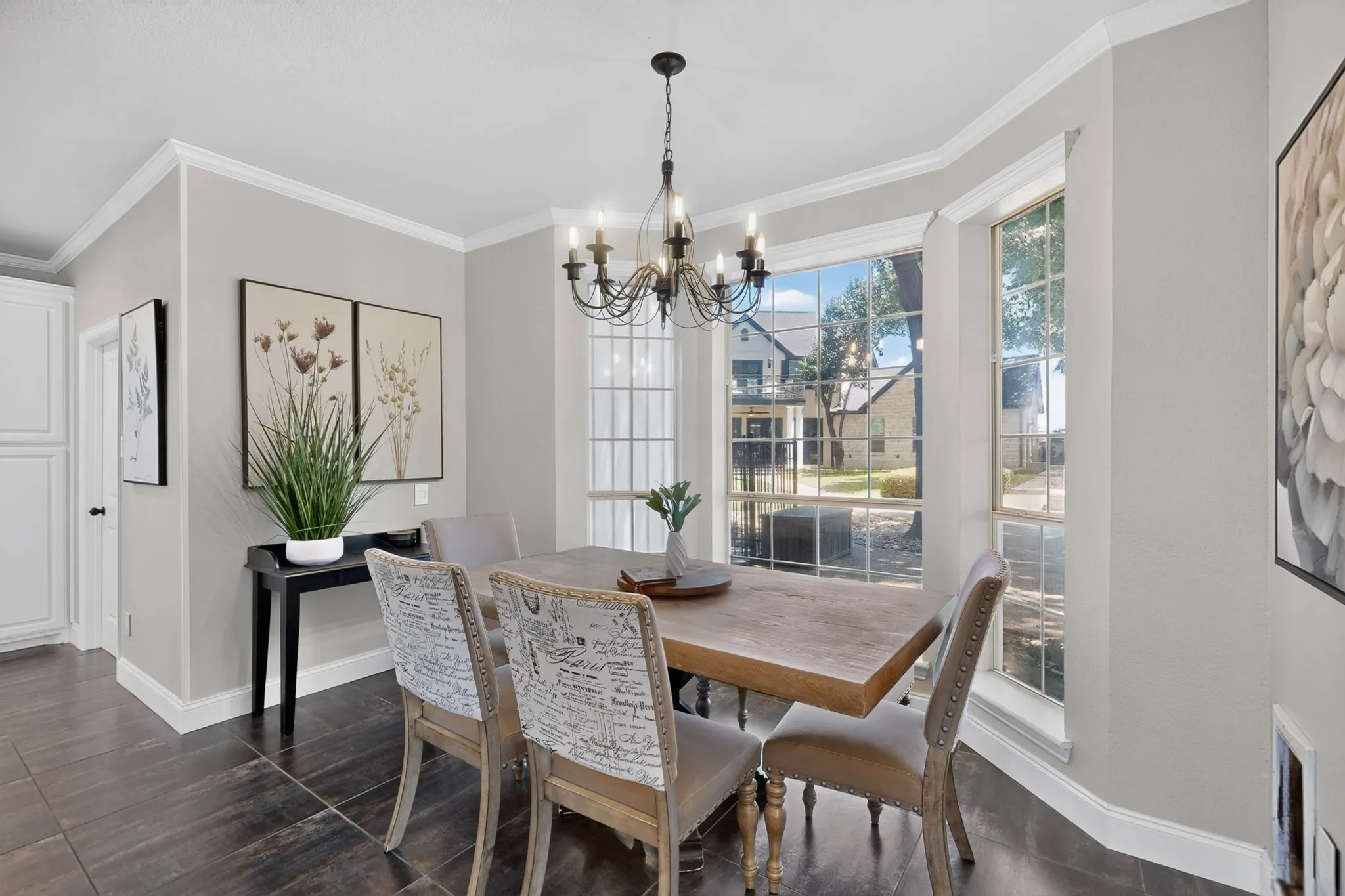 Dining area featuring dark wood-finish flooring, light grey walls, and white crown molding