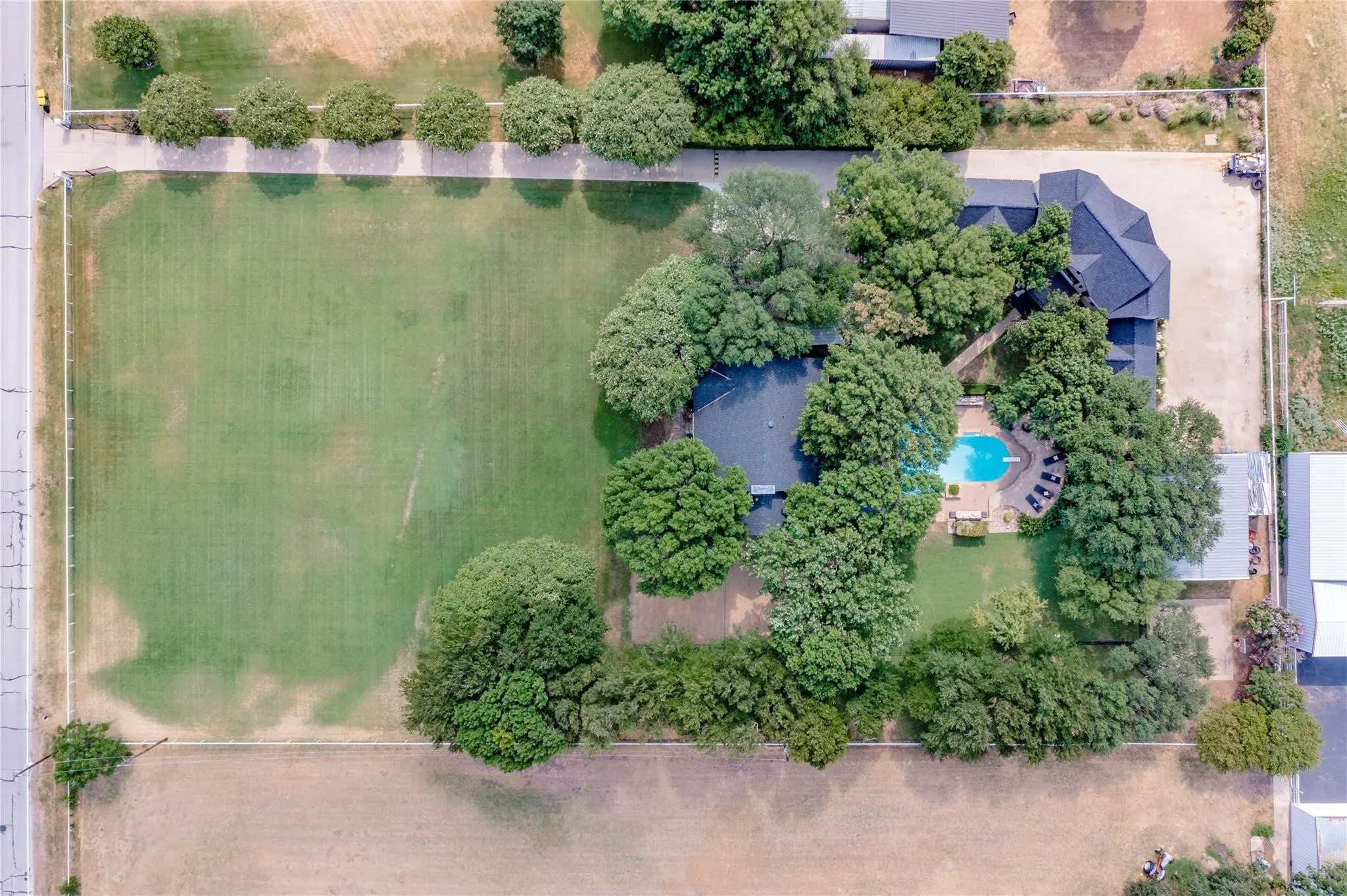 Expansive property with a large, manicured lawn and mature trees