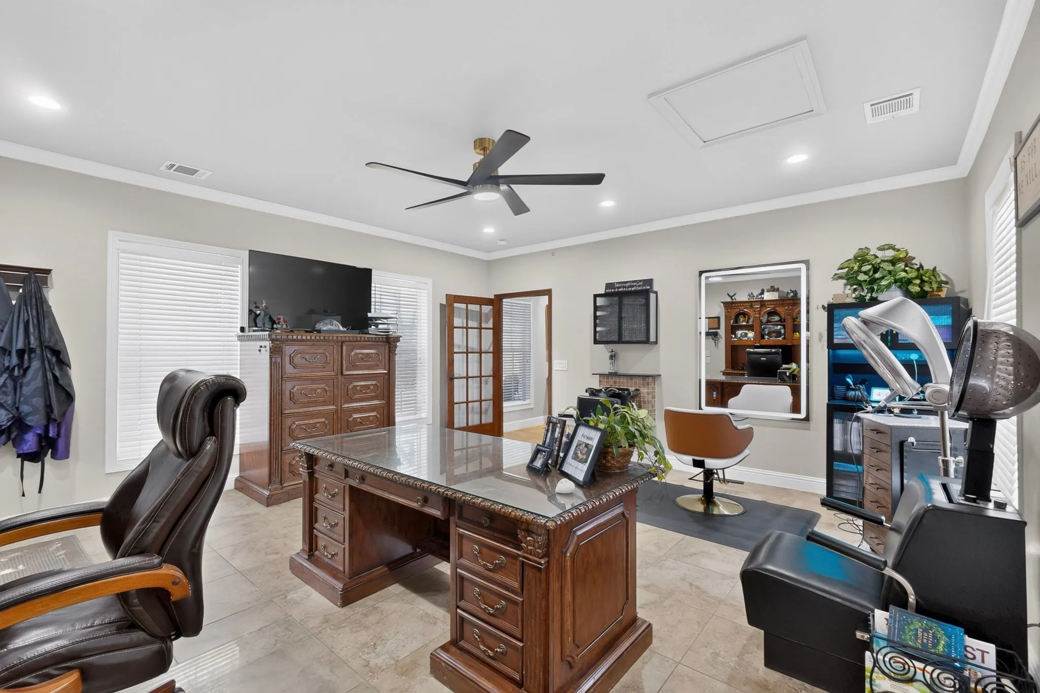 Spacious room featuring multiple windows, a ceiling fan, recessed lighting, and tile flooring