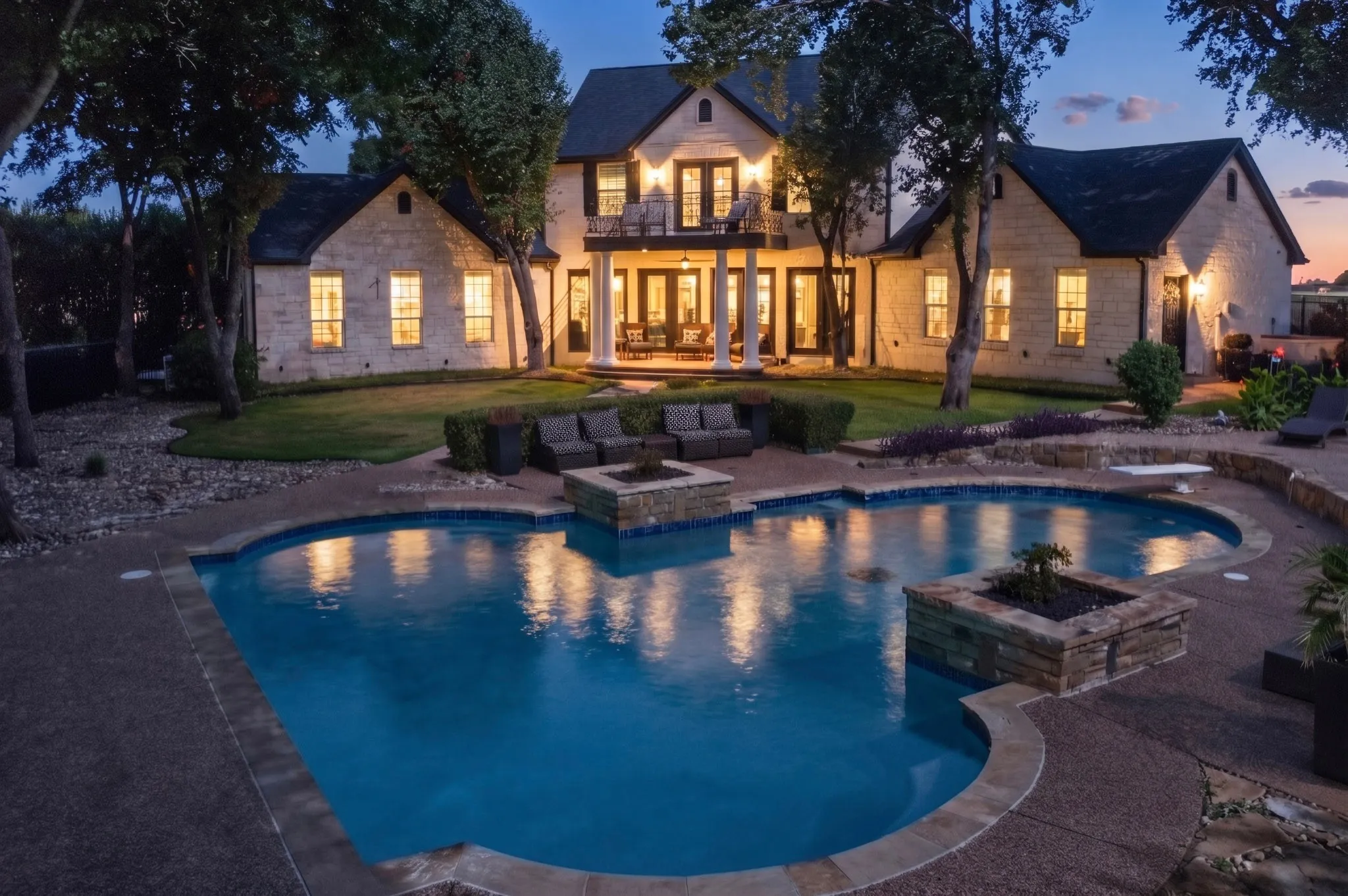 Custom-shaped swimming pool featuring a stone coping and aggregate decking