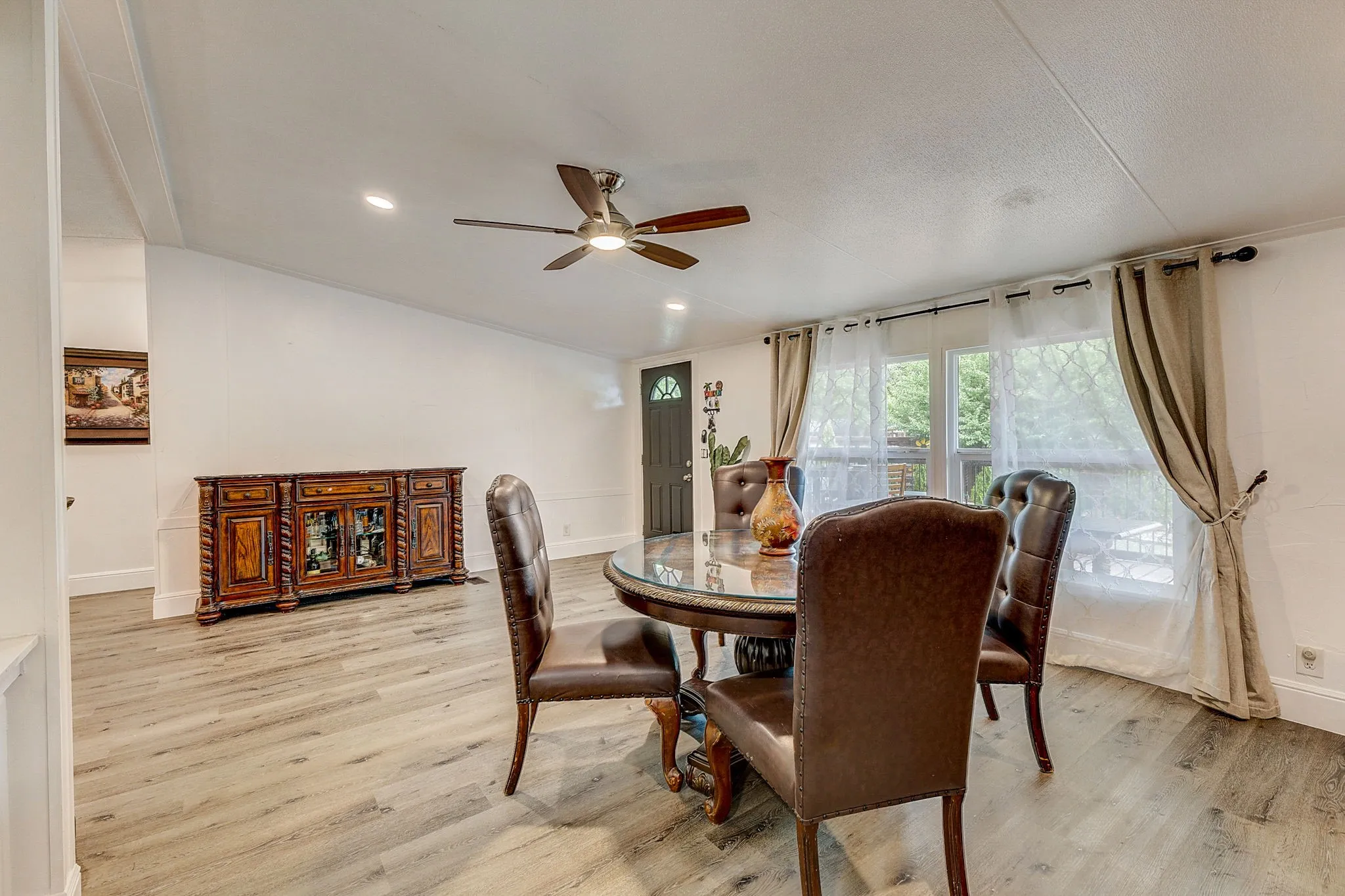 Dining space with ceiling fan and wood-type flooring