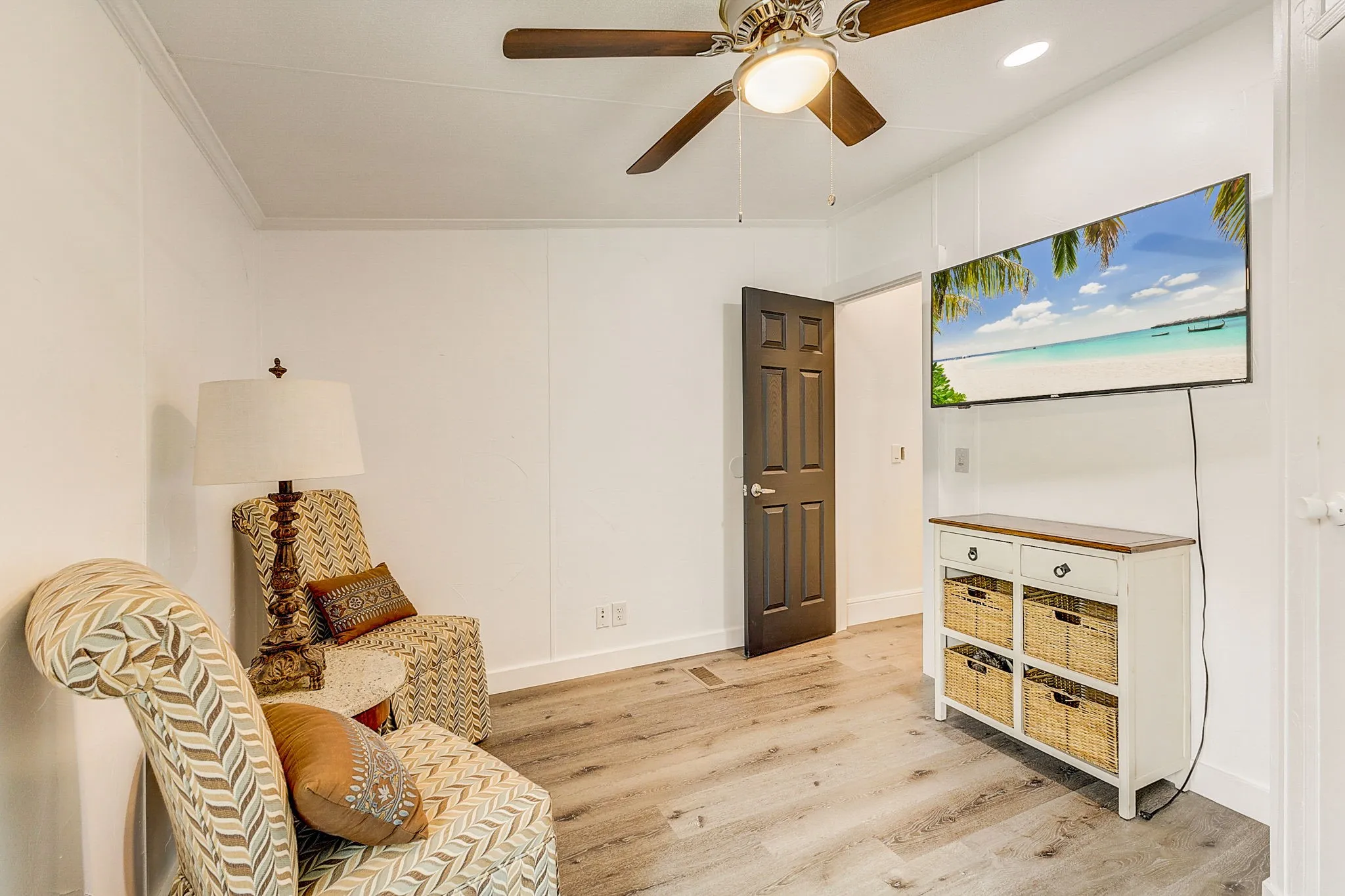 Bedroom with ceiling fan, crown molding, and luxury vinyl floors