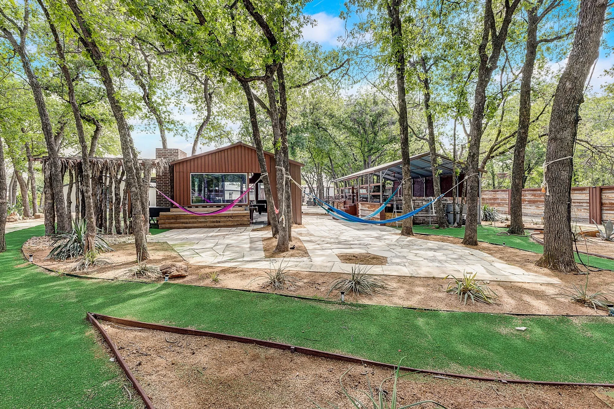 View of yard featuring a playground, BBQ, Hammocks, Swimming pool, and game room, large outdoor entertainment area.