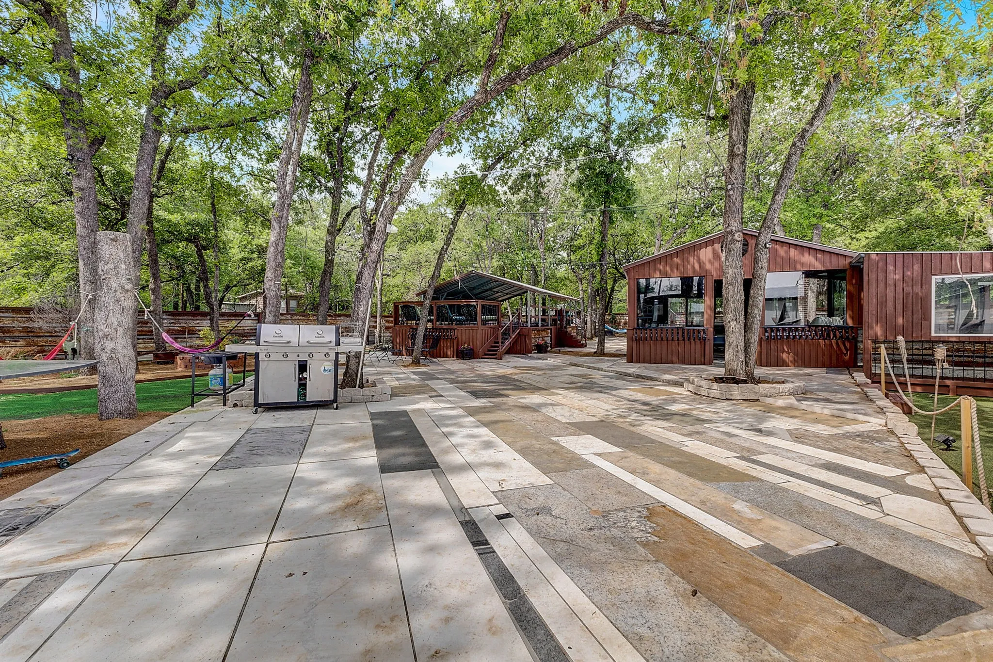 View of yard featuring a playground, BBQ, Hammocks, Swimming pool, and game room, large outdoor entertainment area.