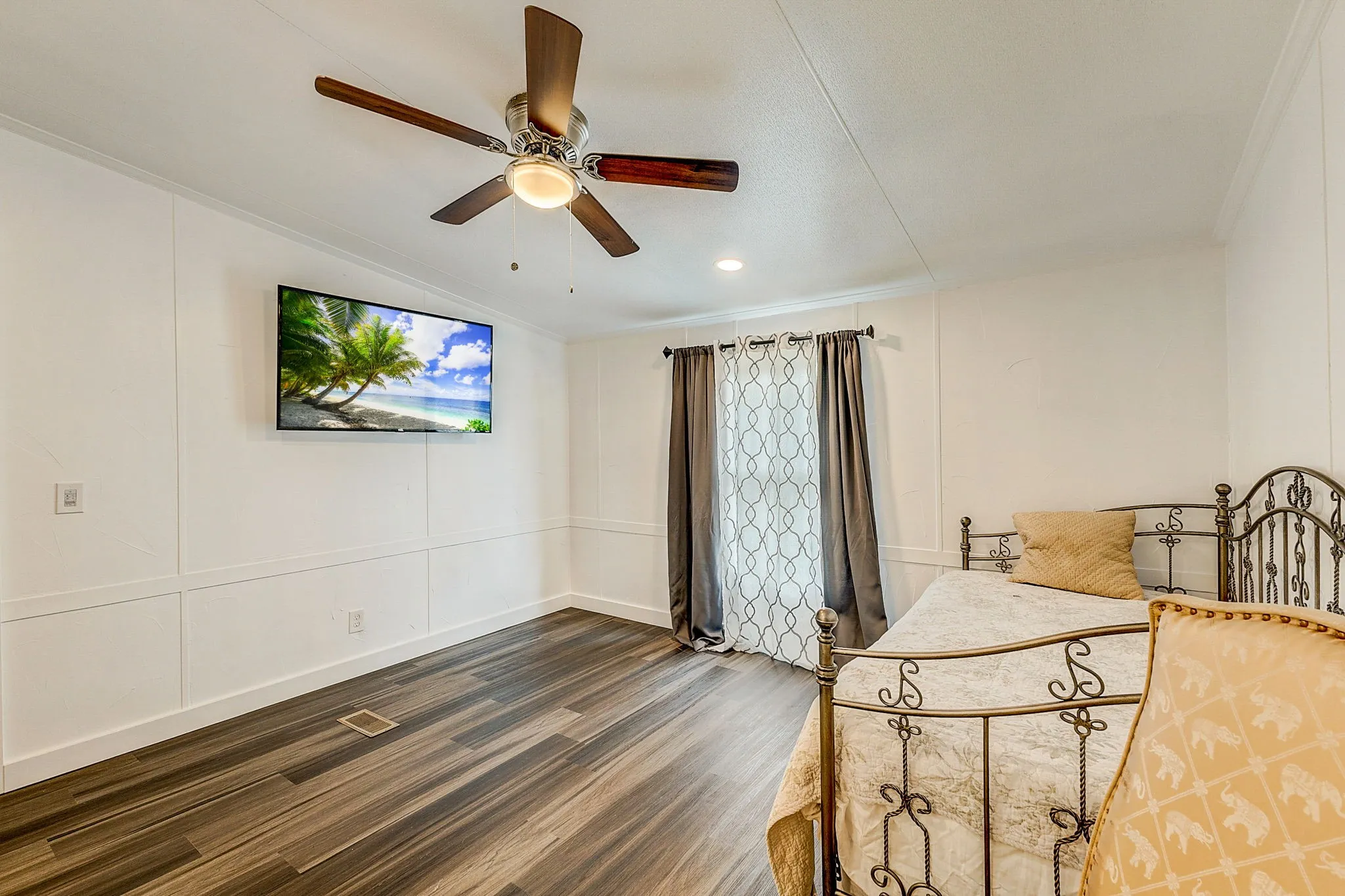Bedroom with ceiling fan, crown molding, and luxury vinyl floors