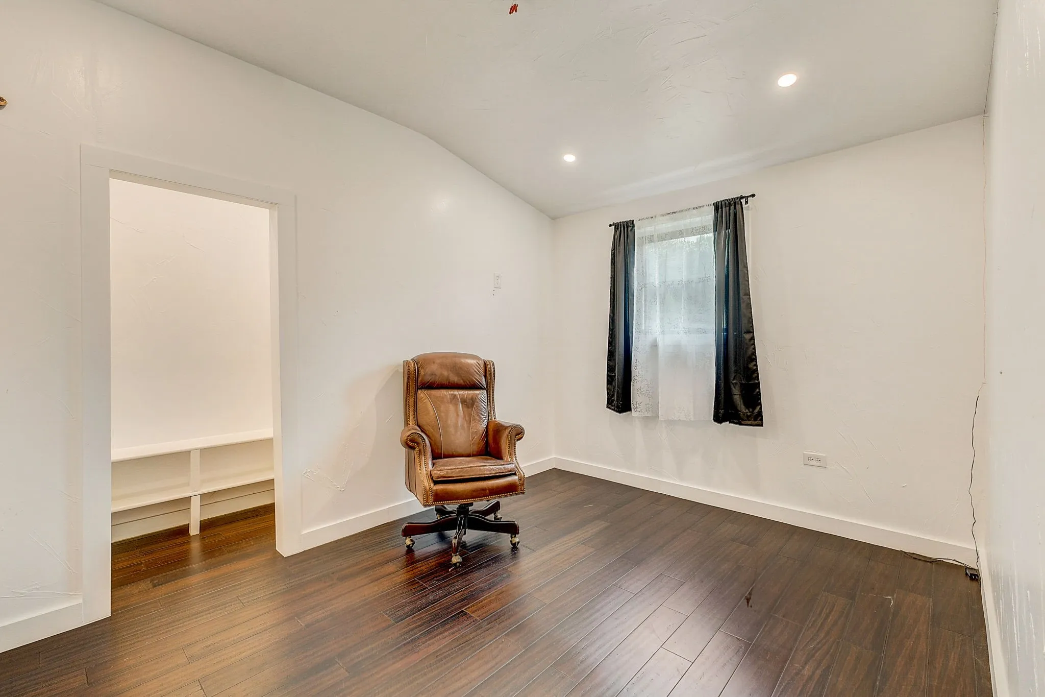 Bedroom with ceiling fan, crown molding, and luxury vinyl floors