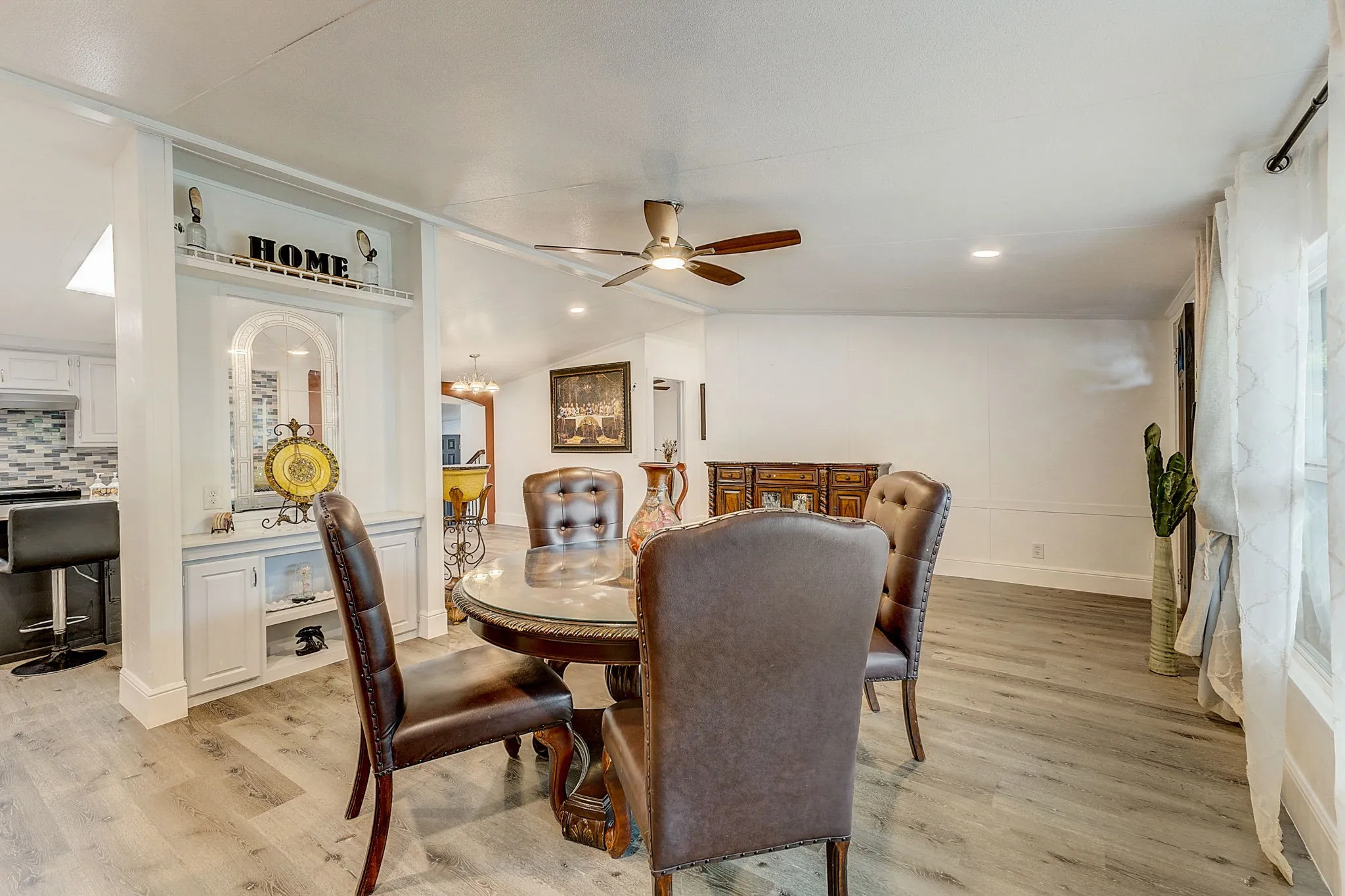 Dining space with ceiling fan and wood-type flooring