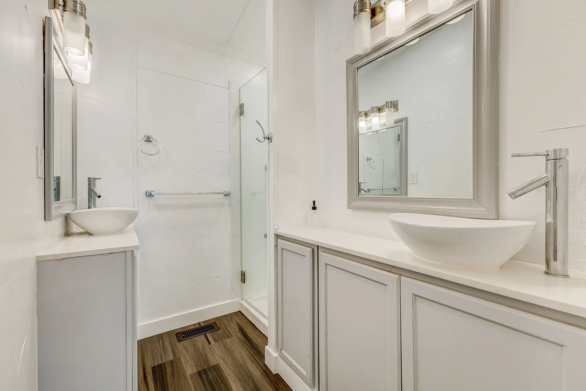 Bathroom featuring walk in shower, ornamental molding, vanity, and hardwood / wood-style floors