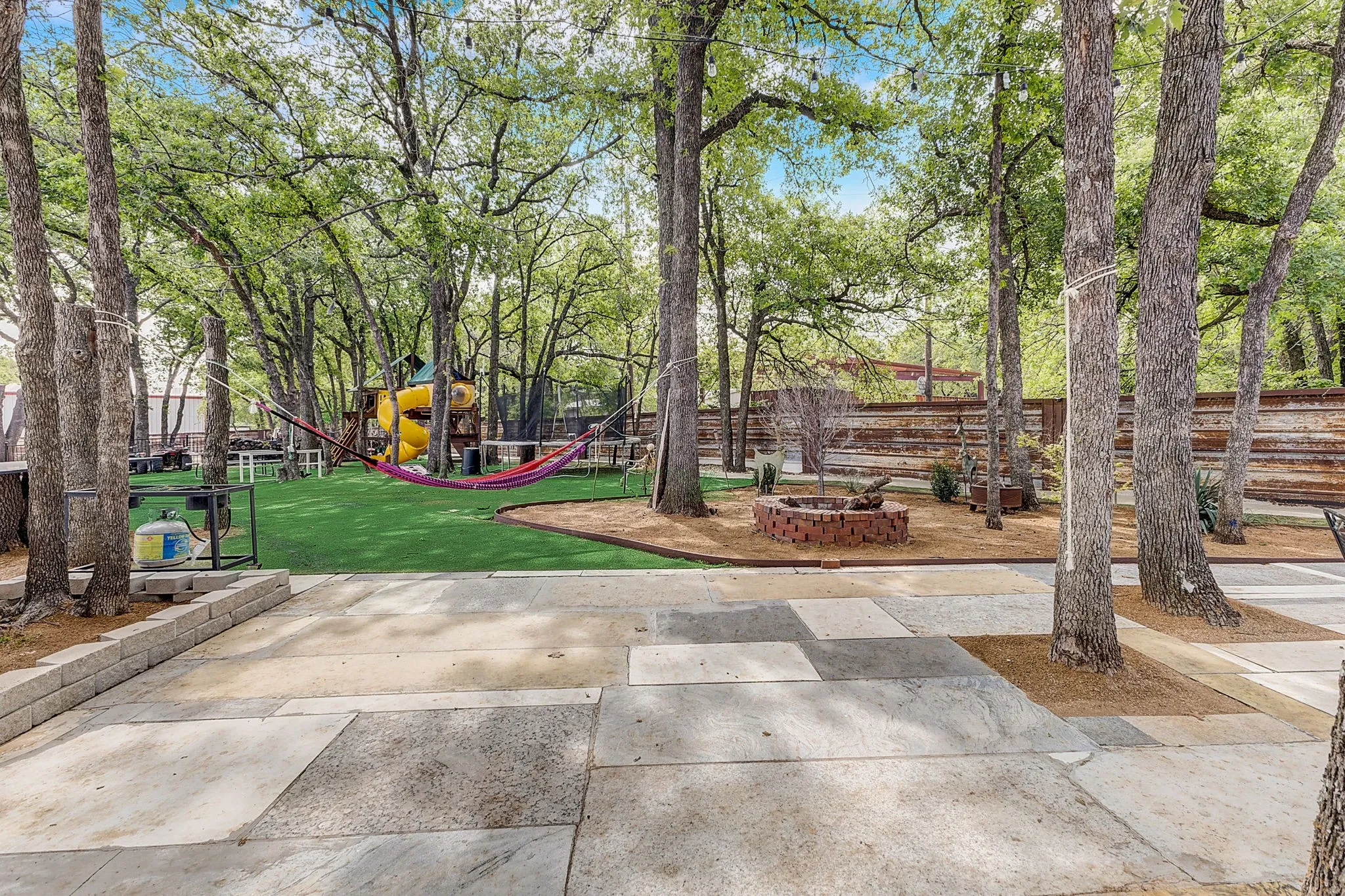 View of yard featuring a playground, BBQ, Hammocks, Swimming pool, and game room, large outdoor entertainment area.