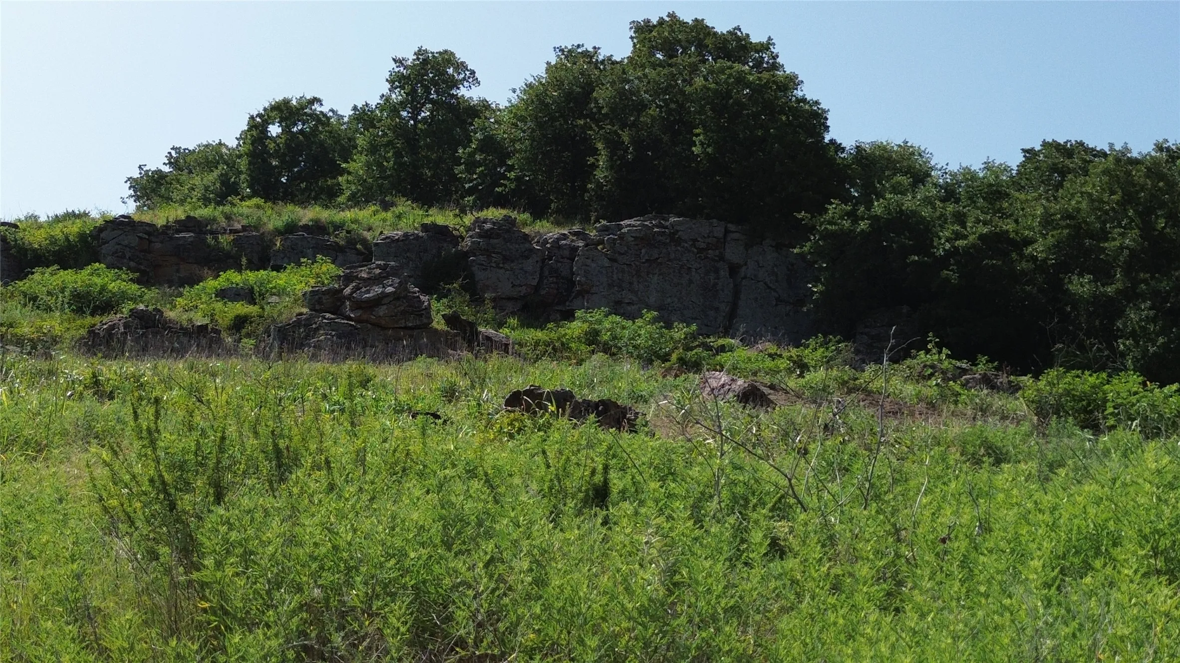 Natural rock formations and dense foliage define the upper terrain