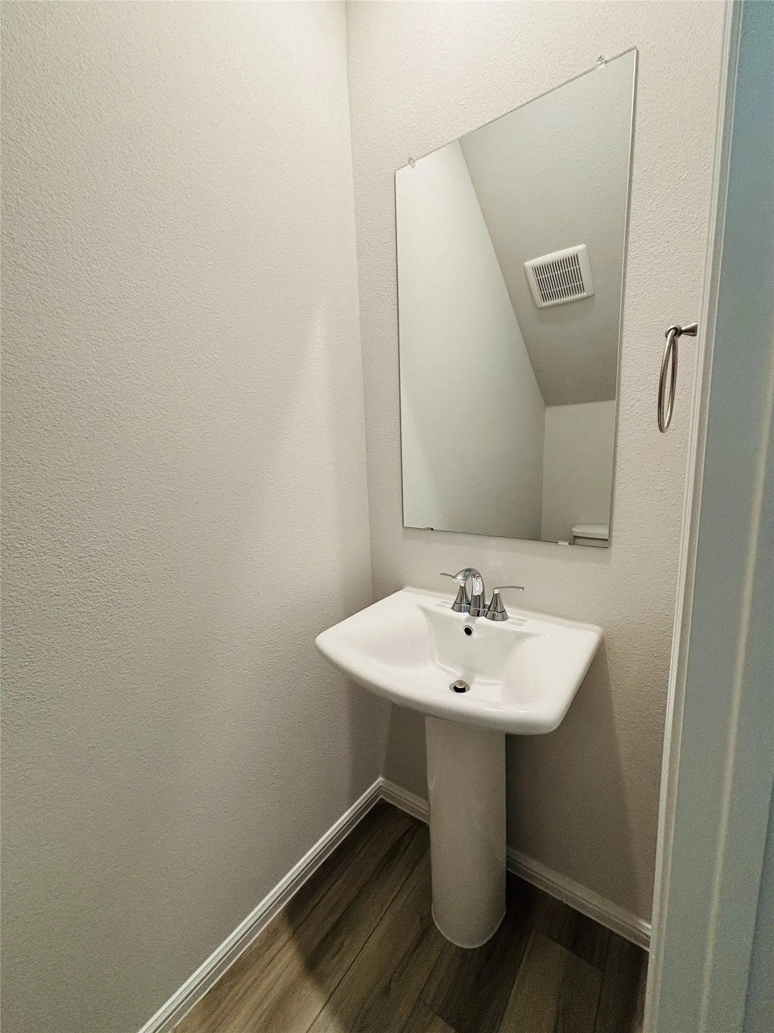 Bathroom featuring wood finished floors and baseboards