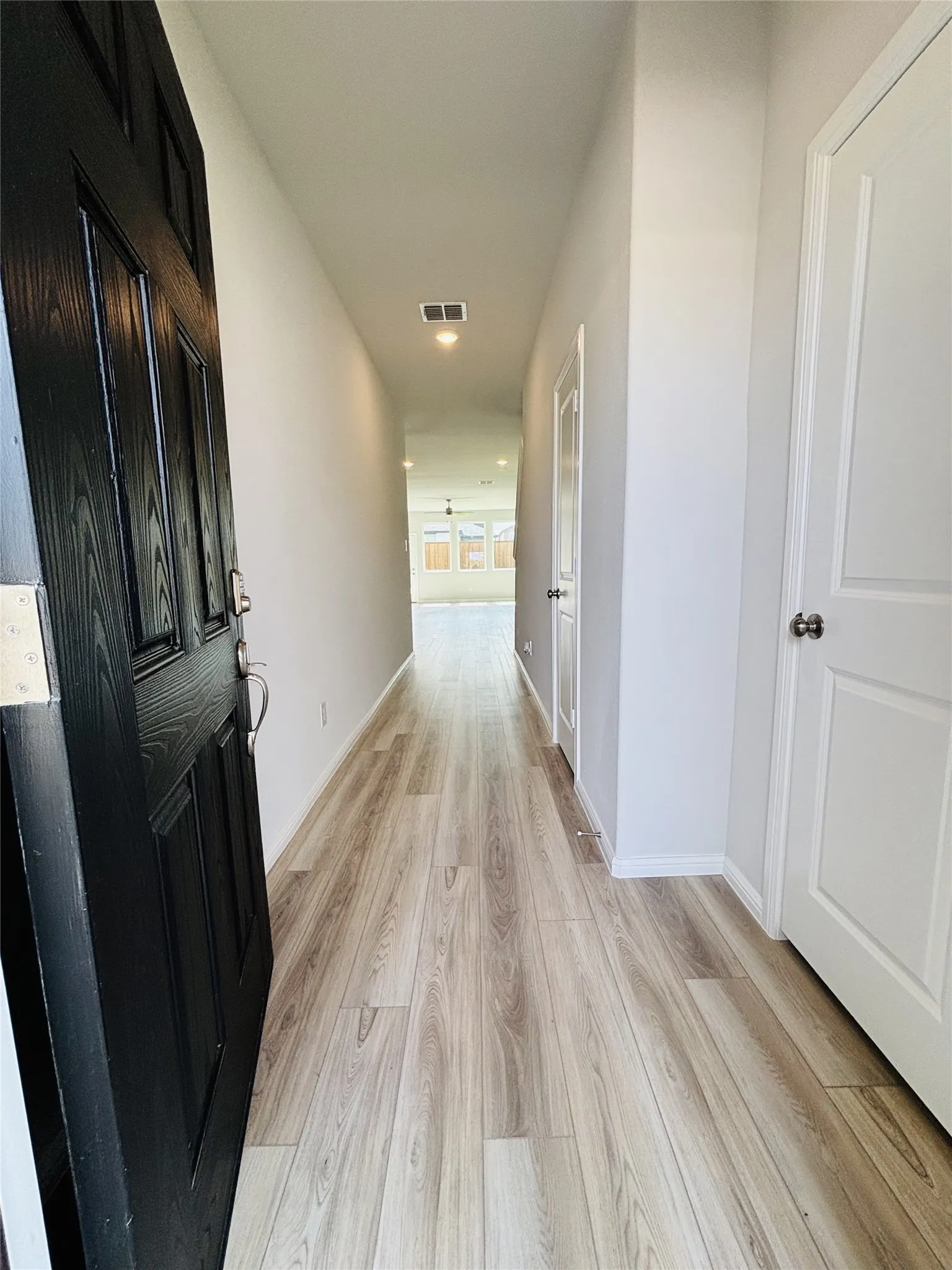 Hall featuring light wood-type flooring and recessed lighting