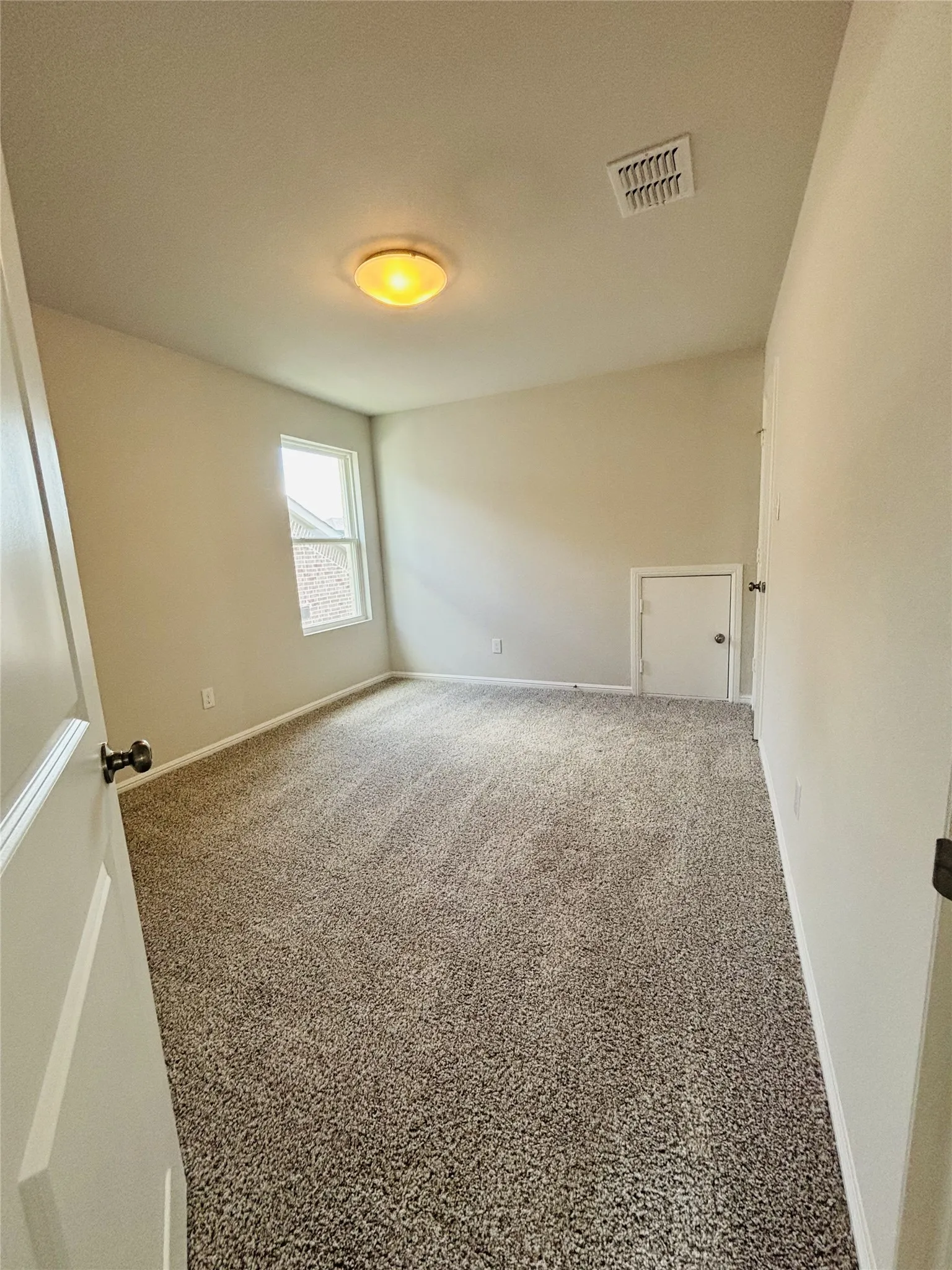 Spare room with baseboards and carpet floors