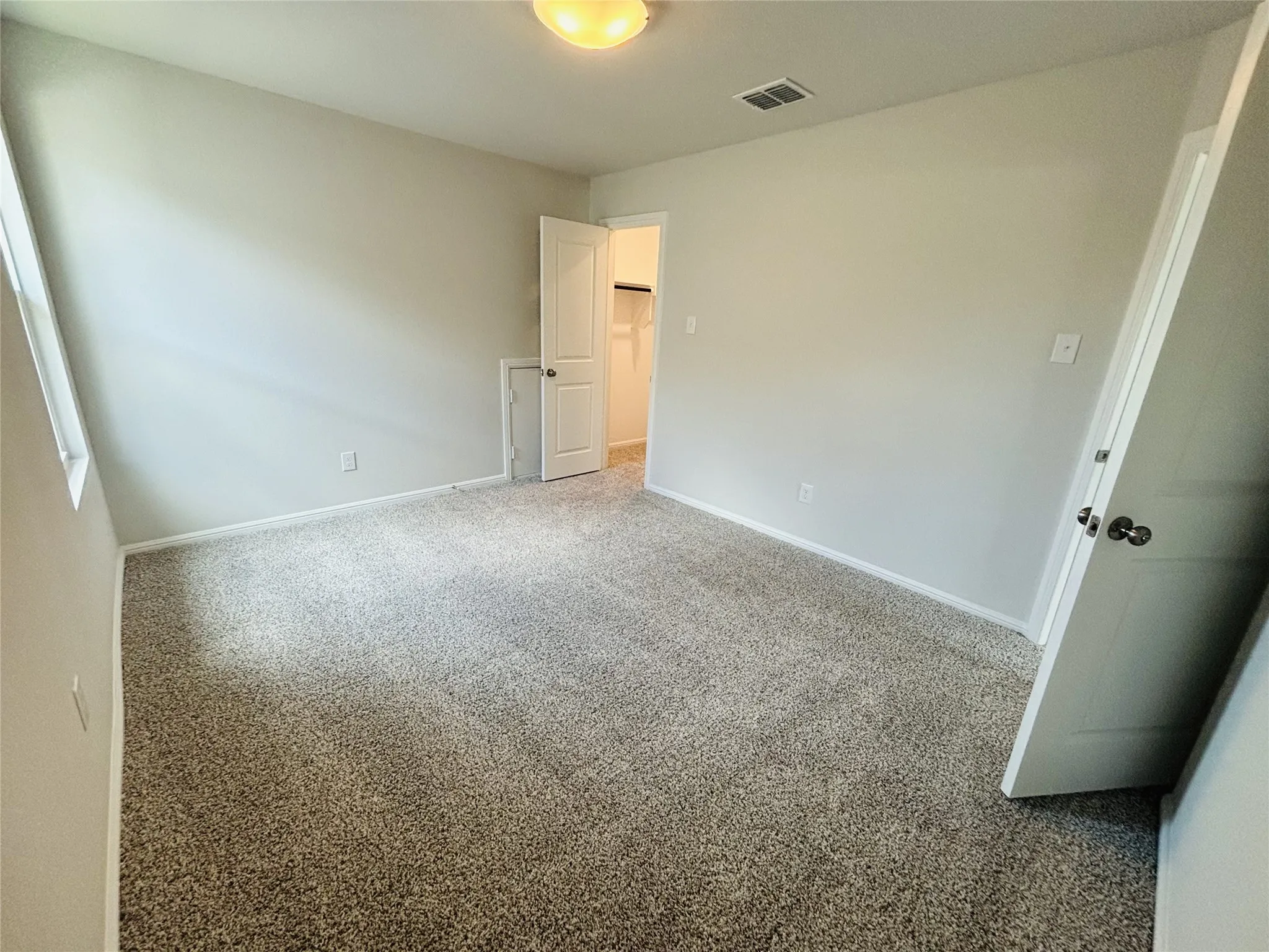 Unfurnished bedroom with carpet
