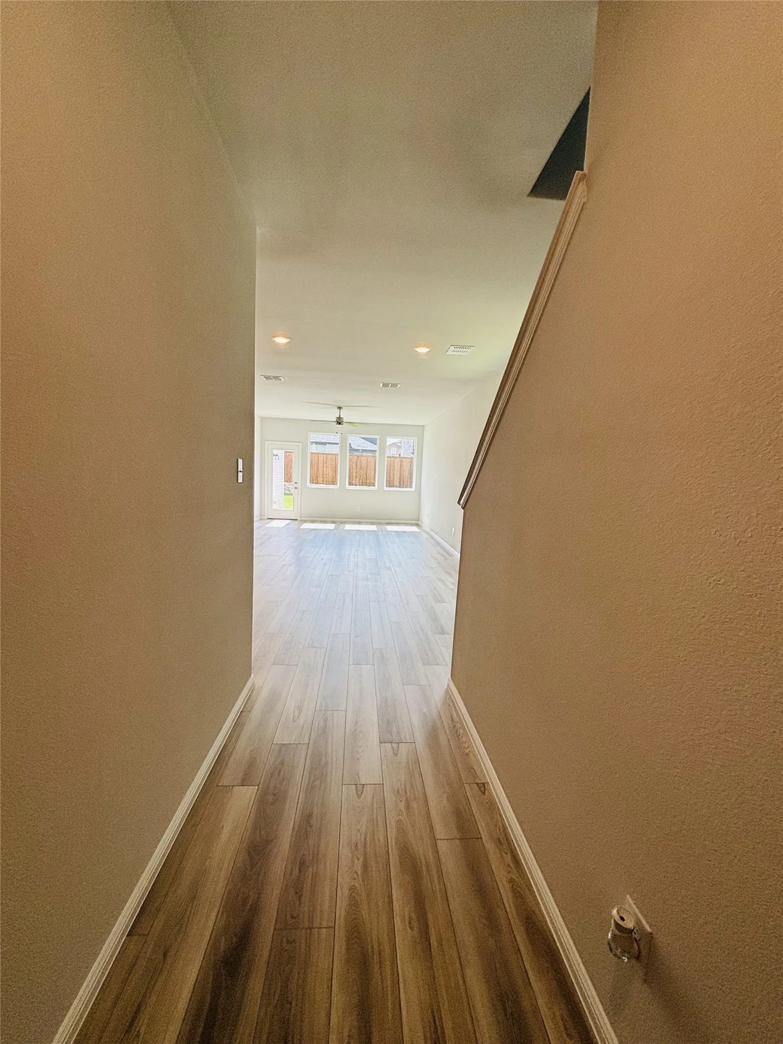 Hall featuring wood finished floors and recessed lighting