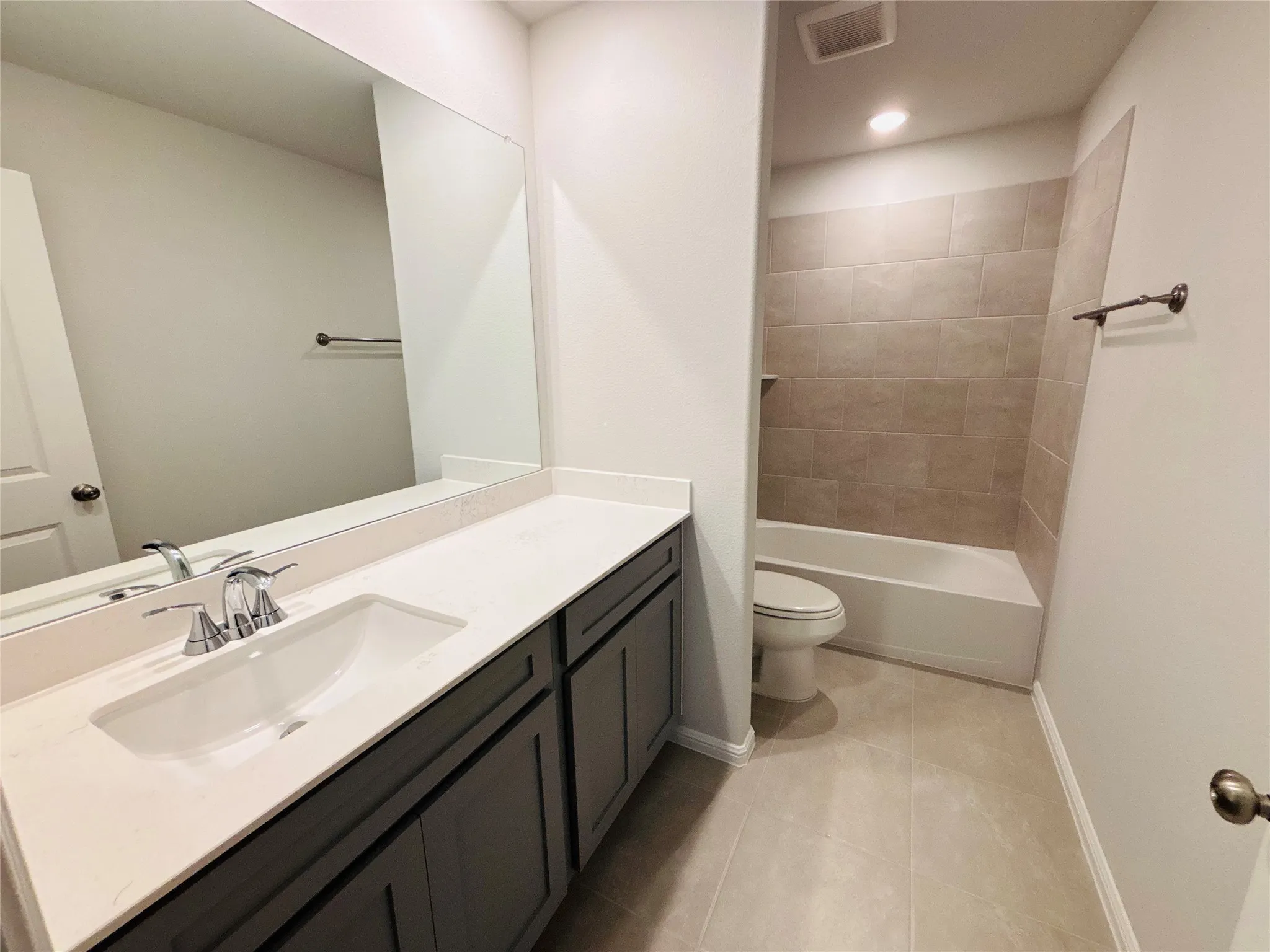 Full bath with vanity, tile patterned flooring, and tub / shower combination
