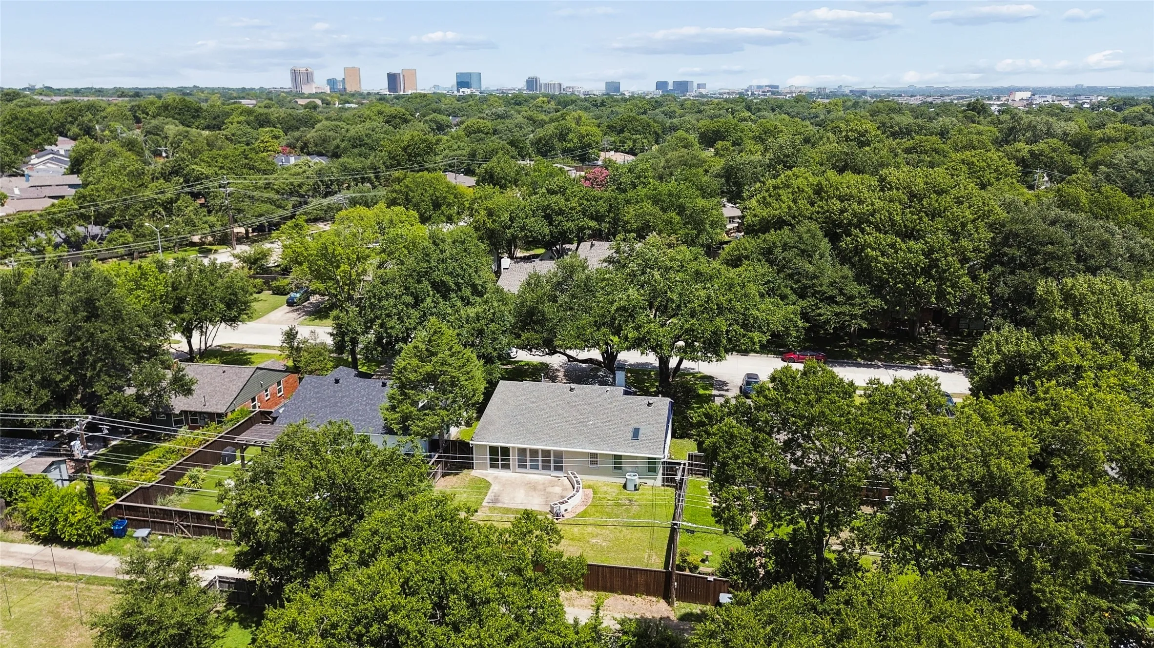 Single-story residential property featuring a light-colored exterior and a gray shingled roof