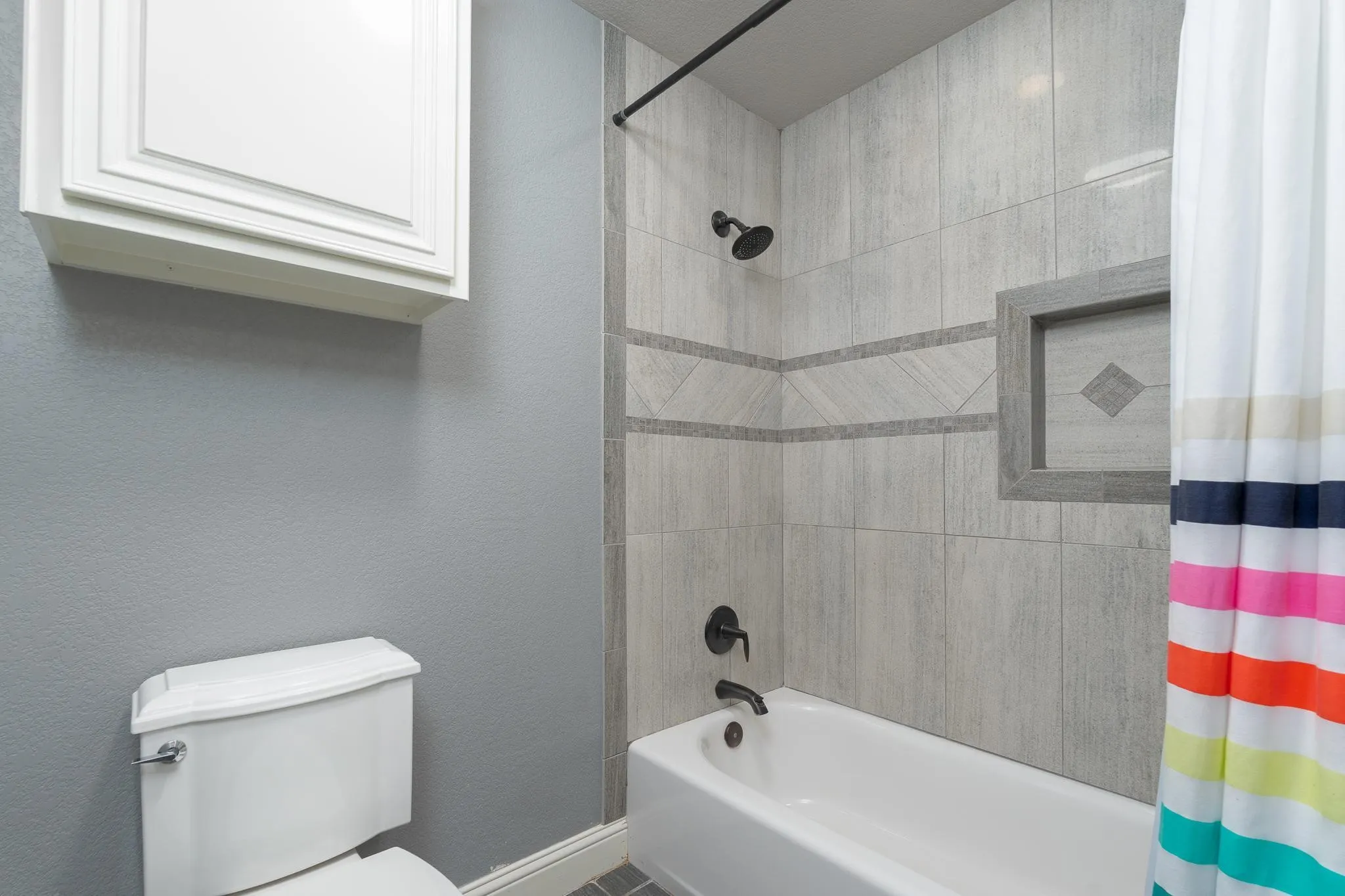 full bathroom with enclosed toilet and tub shower on first floor