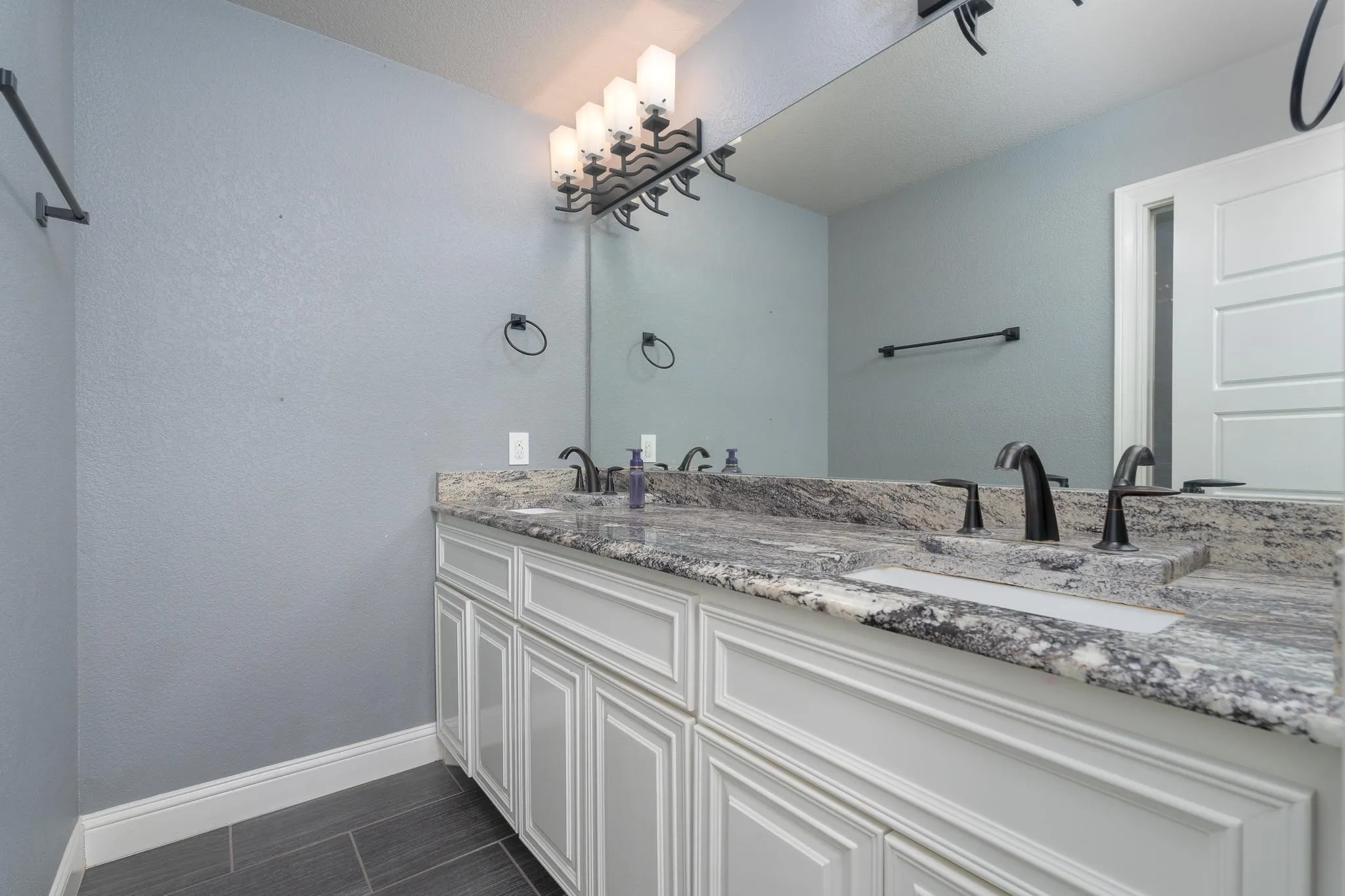 full bathroom with enclosed toilet and tub shower on first floor