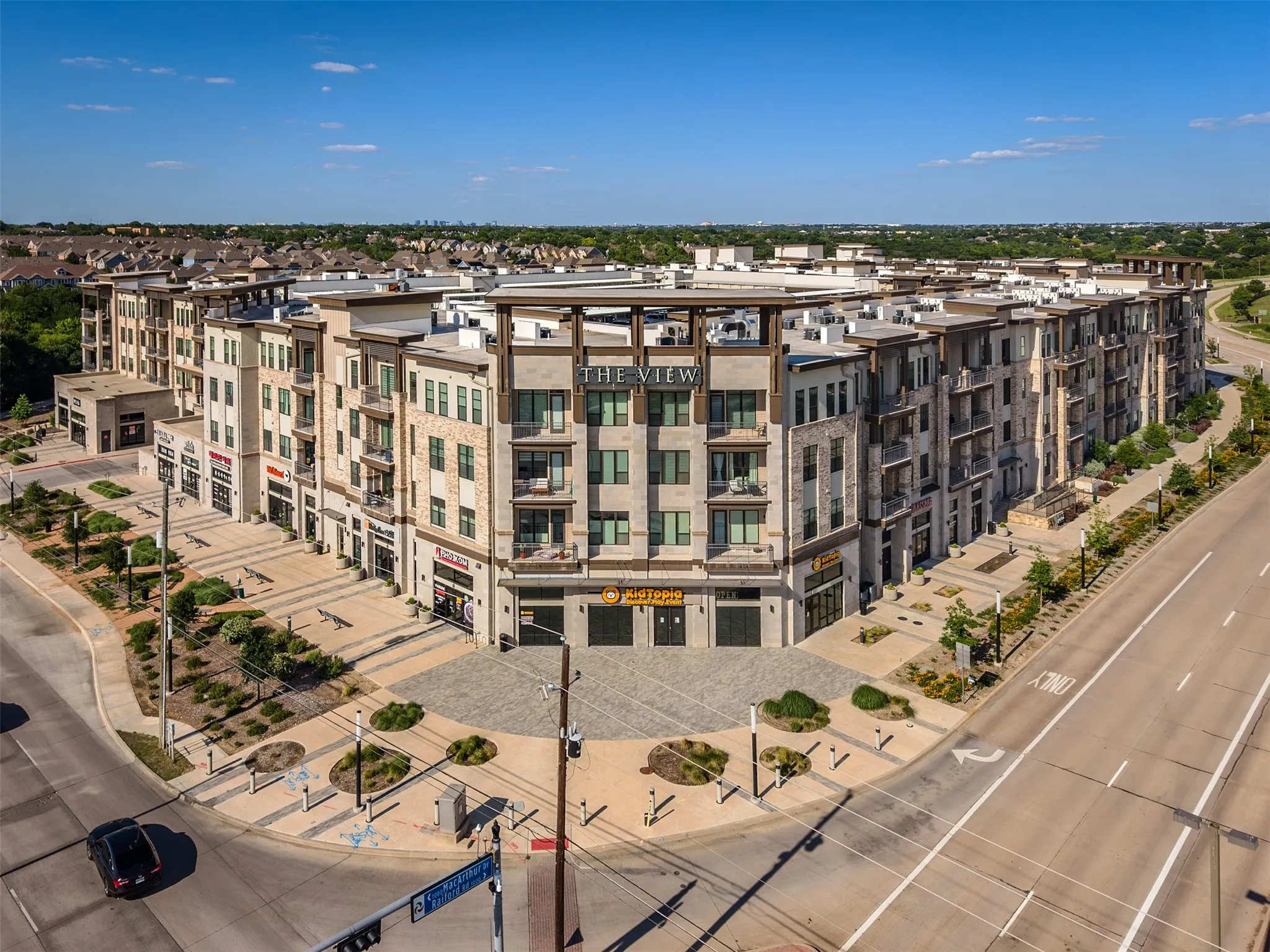 Contemporary mixed-use building featuring multiple stories of residential units above ground-level retail