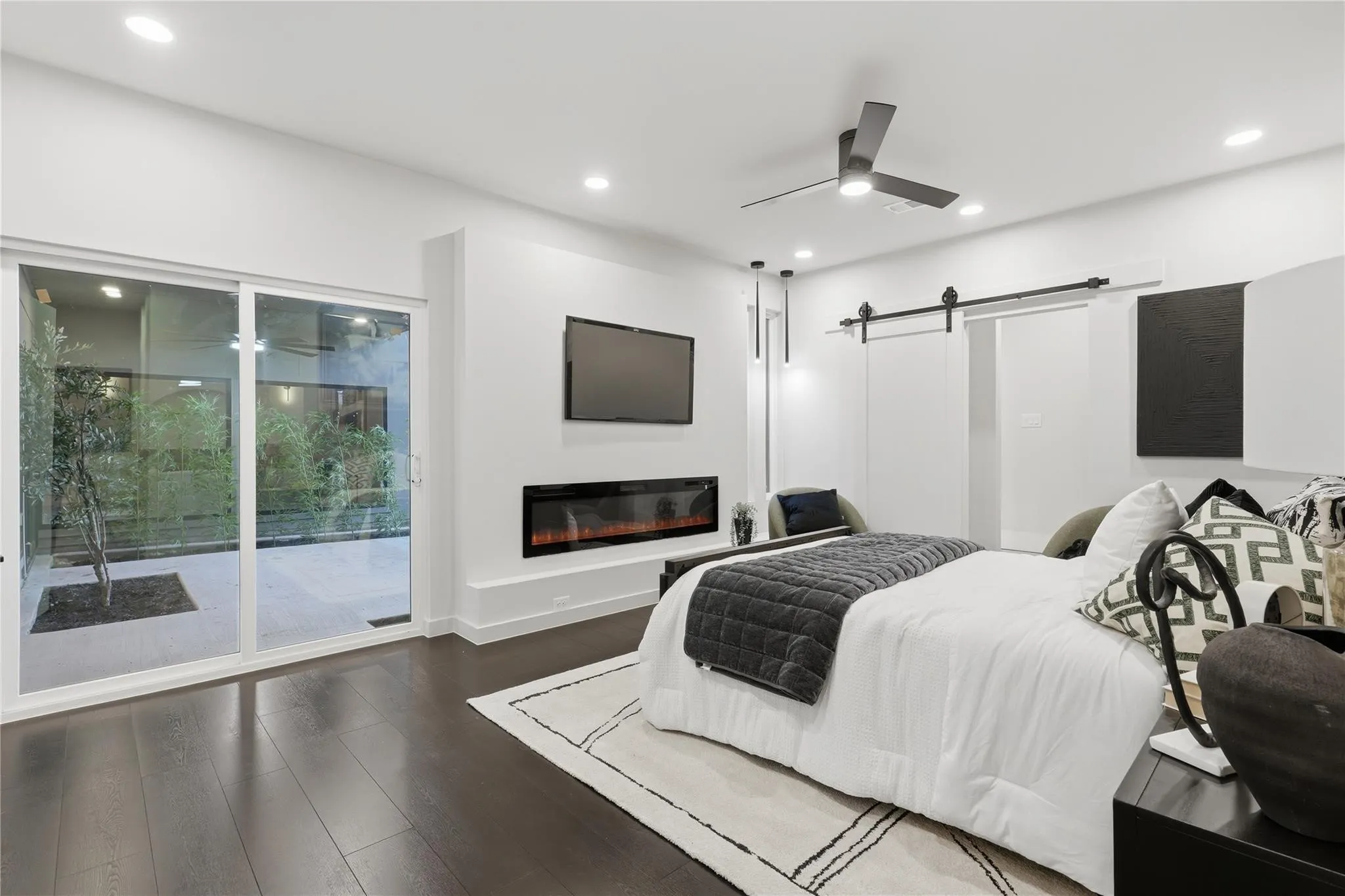Modern interior with dark wood-finish flooring and recessed lighting