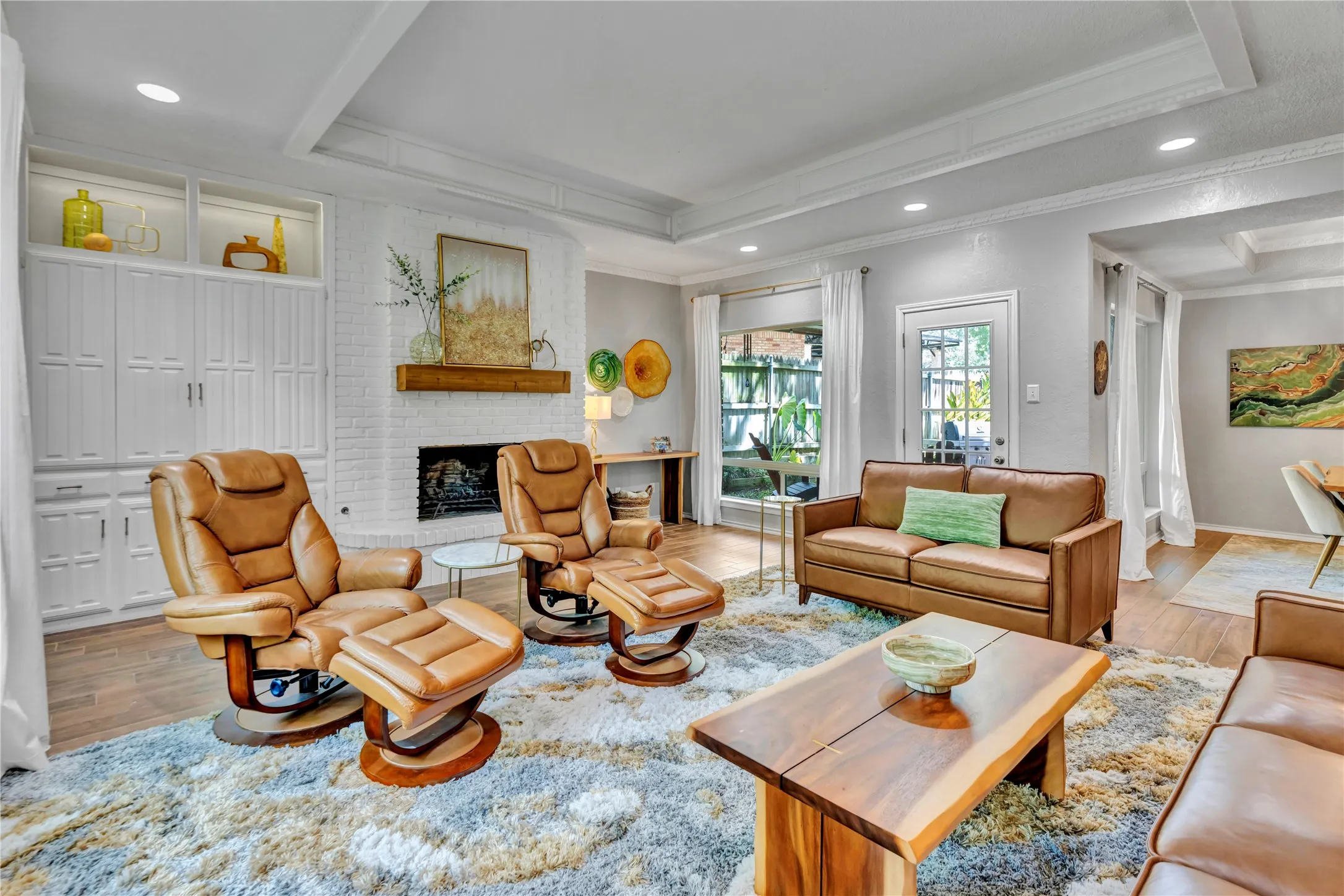 Wood burning fireplace with the TV section behind the built in cabinetry
