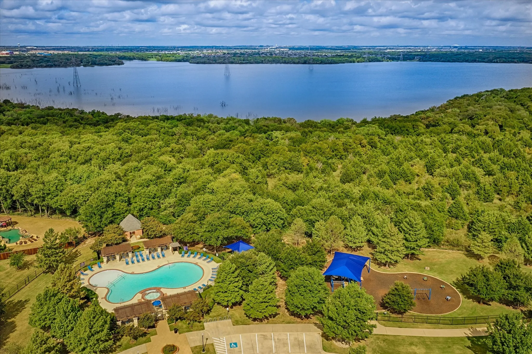Expansive community amenities including a large swimming pool, hot tub, and a separate children's splash pad