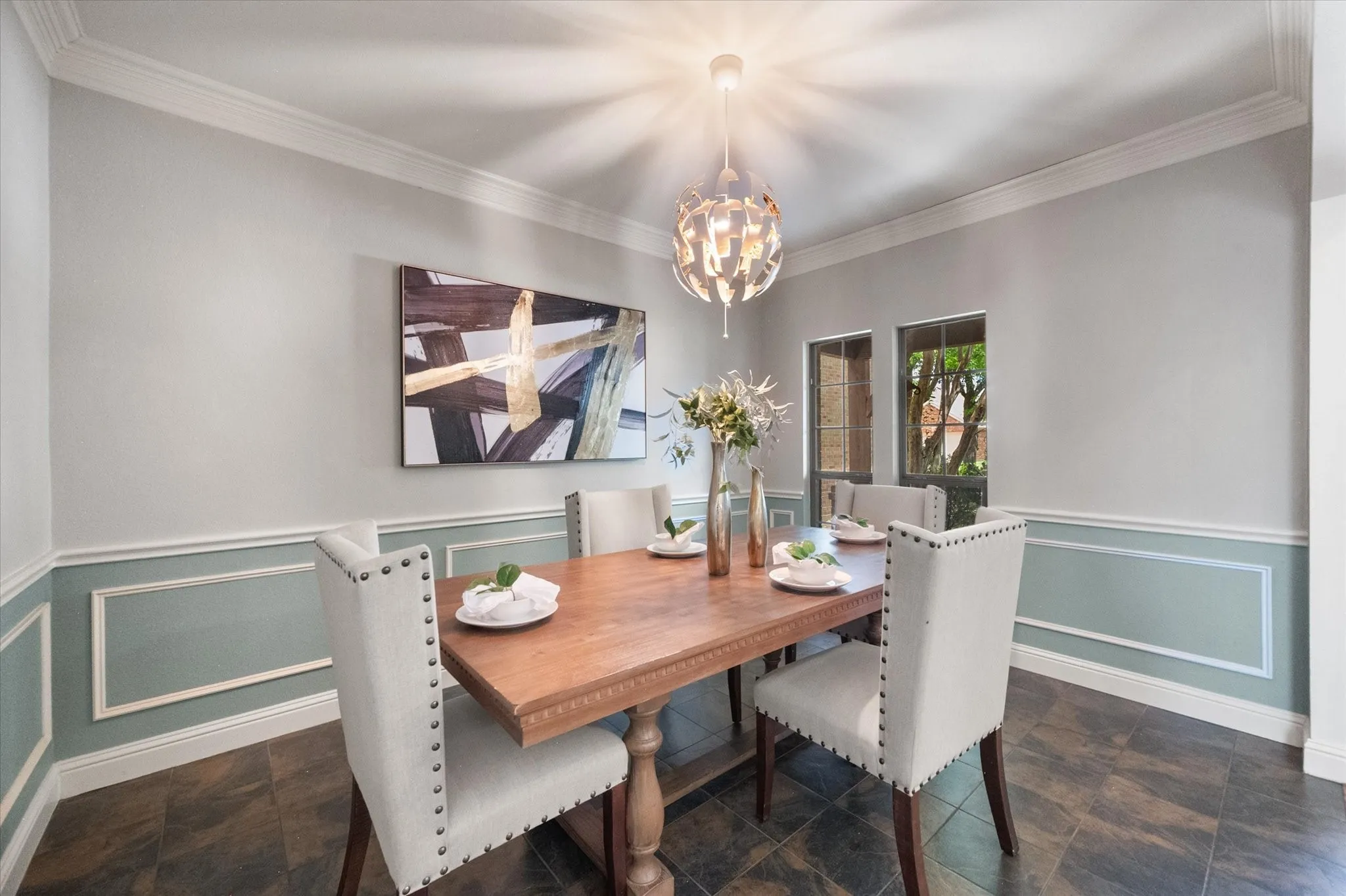 Formal Dining area featuring a contemporary chandelier and crown molding