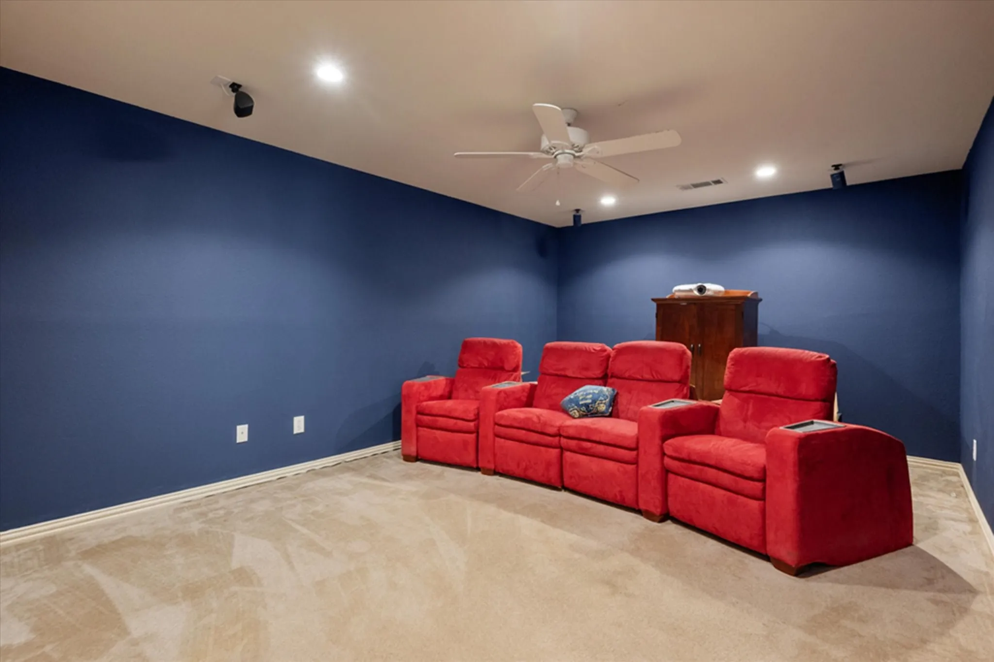 Dedicated media room featuring recessed lighting, a ceiling fan, and track-mounted speakers