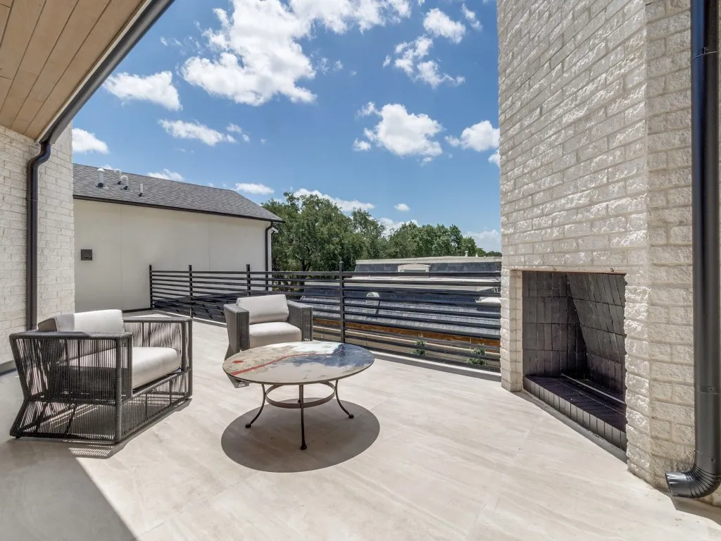 Outdoor living at it's best on a balcony with a fireplace