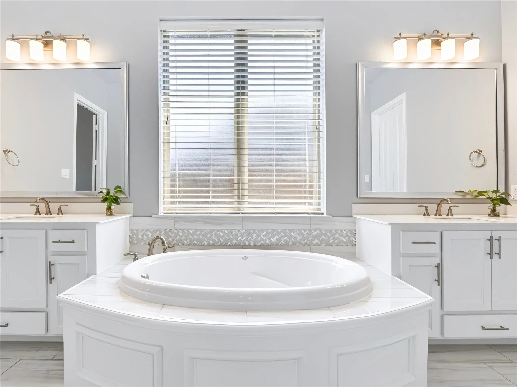 Dual vanity with undermount sinks, separate mirrors, and dedicated lighting
