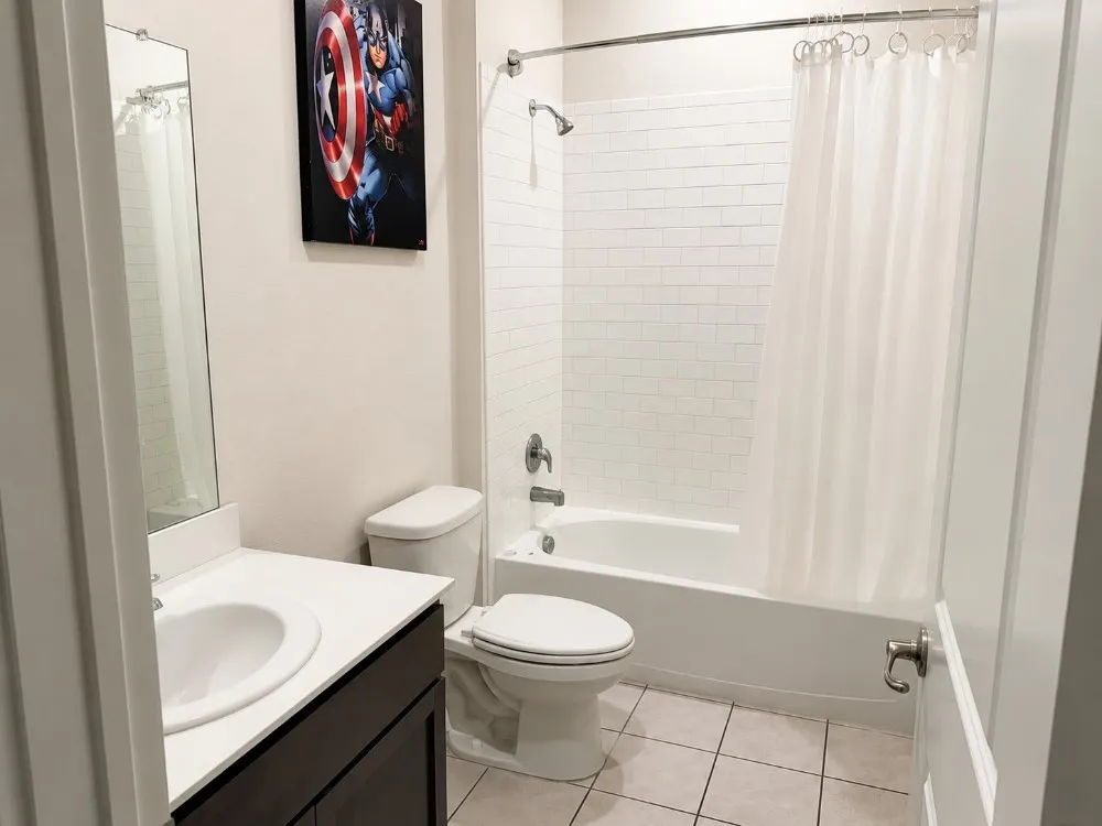 Bathroom featuring a vanity with an integrated sink, dark wood-finish cabinetry, and a white countertop