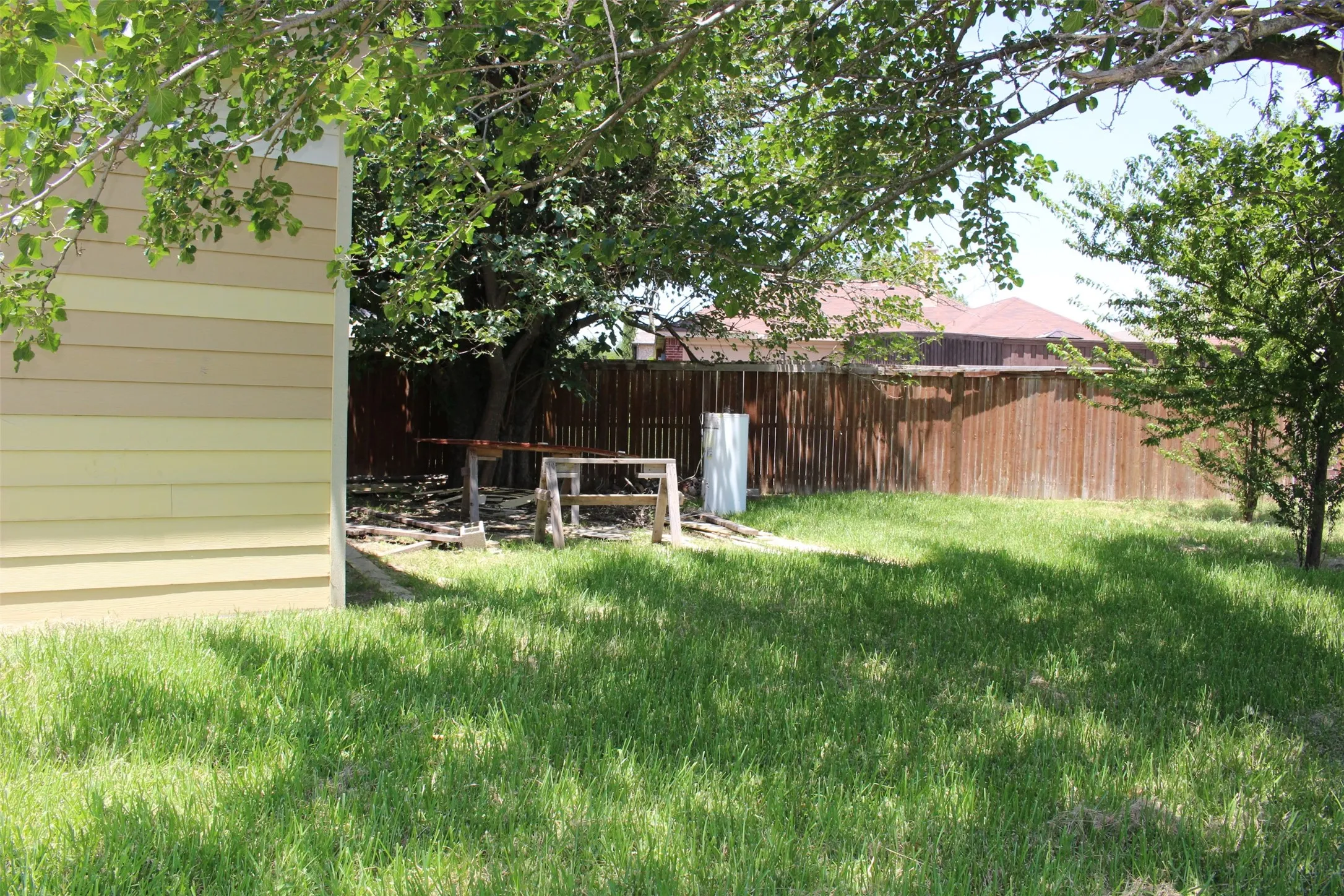 Expansive grassed yard with mature trees providing natural shade