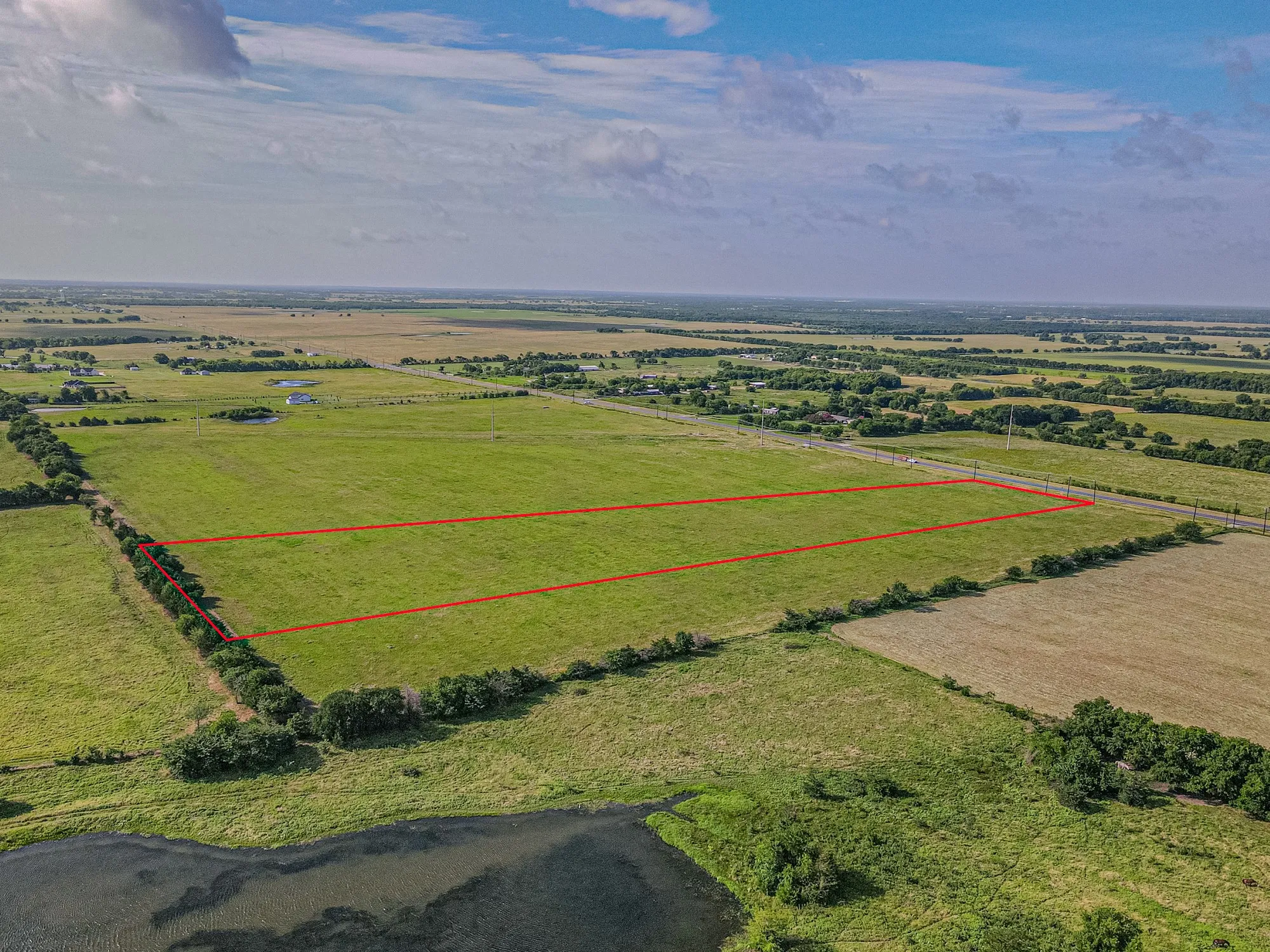 Expansive land parcel featuring open green fields