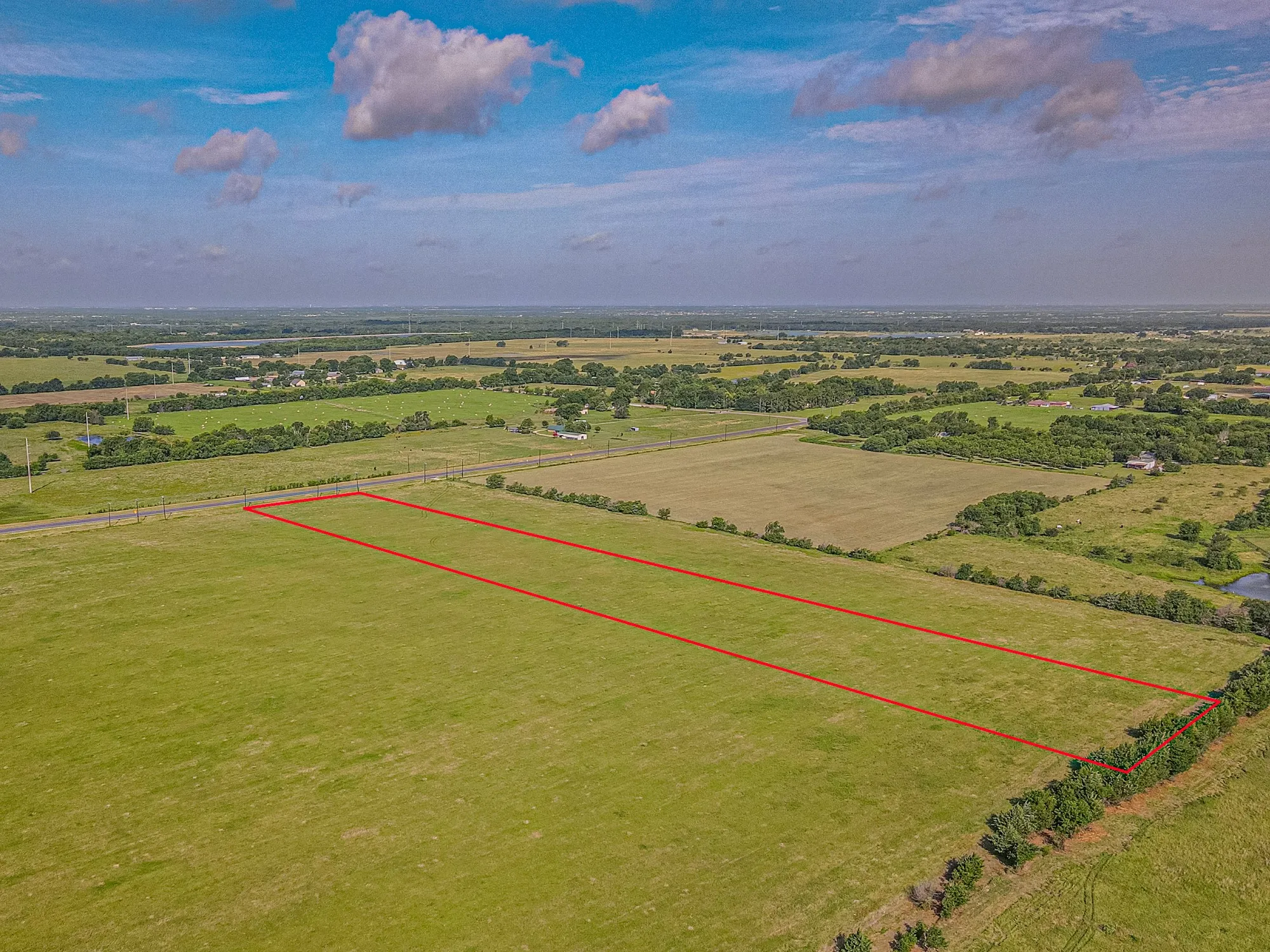 Expansive rural acreage featuring a level, green pasture